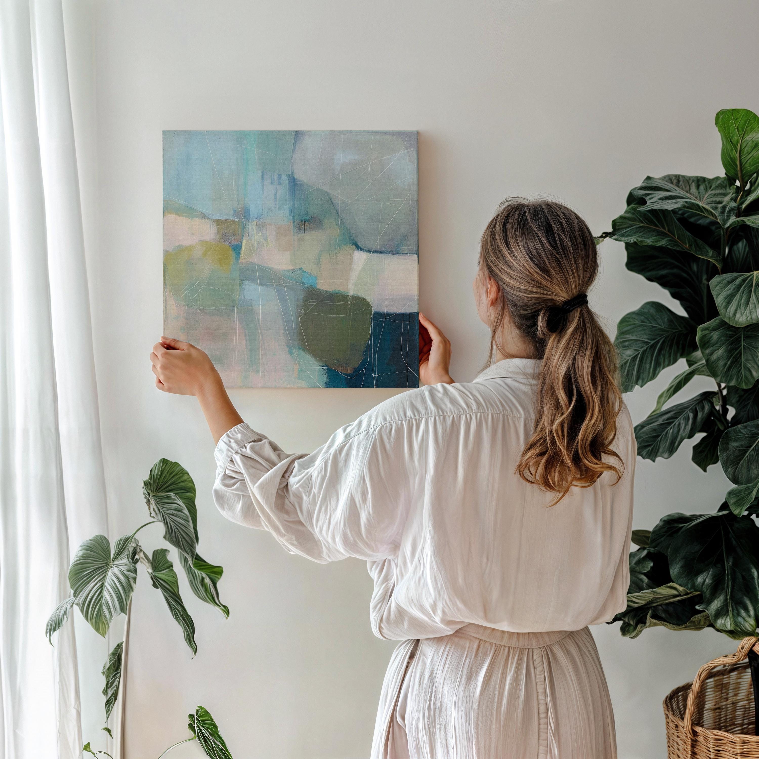 Square coastal abstract wall art in blue, coral, and ivory tones with soft coastal styling; ideal for living room, beach house, or bedroom decor. Available as a limited-edition canvas by Muse Studio.