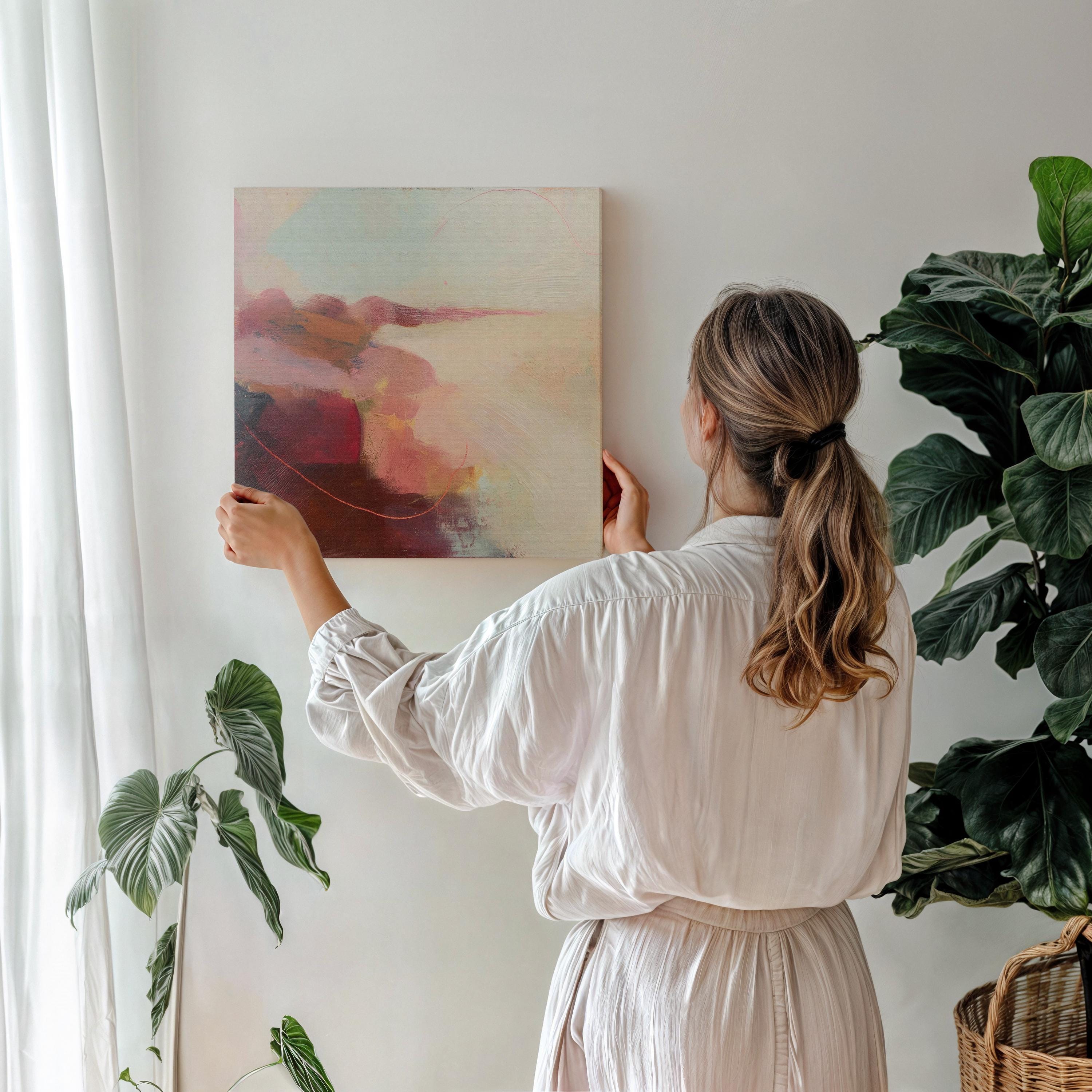 Square abstract canvas wall art featuring soft blush, terracotta, and cream tones with layered painterly textures and horizon-inspired flow. This warm minimal giclée print blends natural earth tones with serene modern design, ideal for living rooms or transitional spaces. Available as gallery-wrapped canvas or floating frame canvas from Muse Studio.