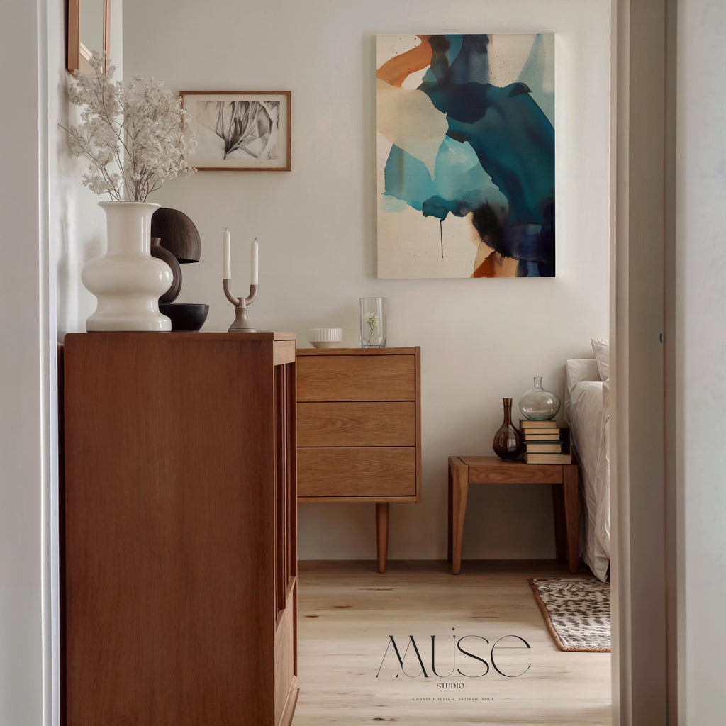 Vertical gallery-wrapped canvas featuring an abstract composition of teal, deep navy, soft aqua, and sand with fluid, ink-like motion across a neutral base. This nature-inspired wall art adds a tranquil, contemporary presence to coastal interiors, entryways, or stairwells. A soft modern statement piece, available as canvas or floating framed wall art from Muse Studio.