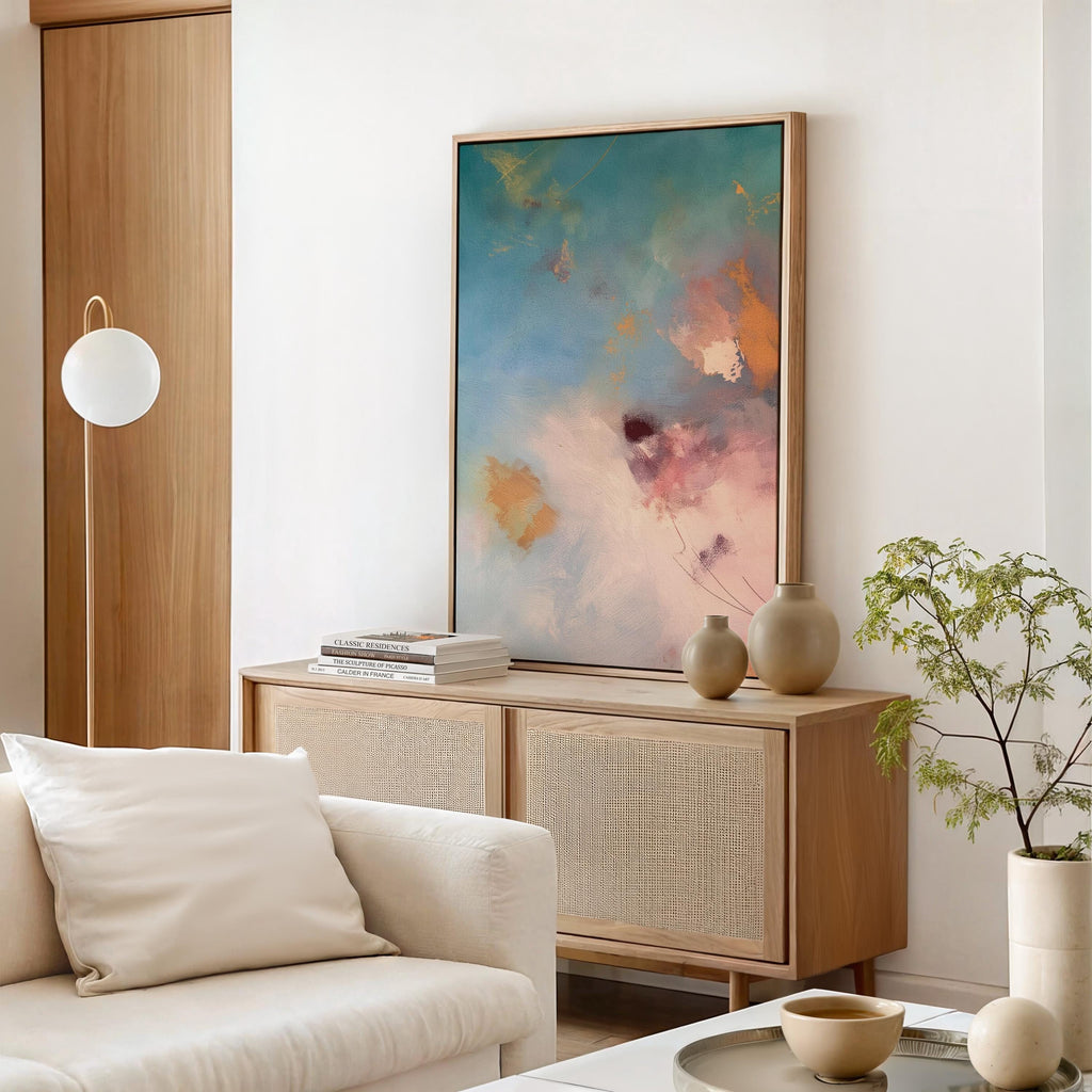 Vertical canvas wall art in soft pastels featuring abstract brushwork in peach pink, sky blue, honey gold, and blush. This gentle and calming piece evokes a sunrise or soft floral bloom, perfect for spa-style bathrooms, feminine bedrooms, or serene entryways. Complements soft contemporary and warm minimalist interiors. Available as a gallery-wrapped stretched canvas, framed canvas, or giclée fine art print. Original artwork by Muse Studio.