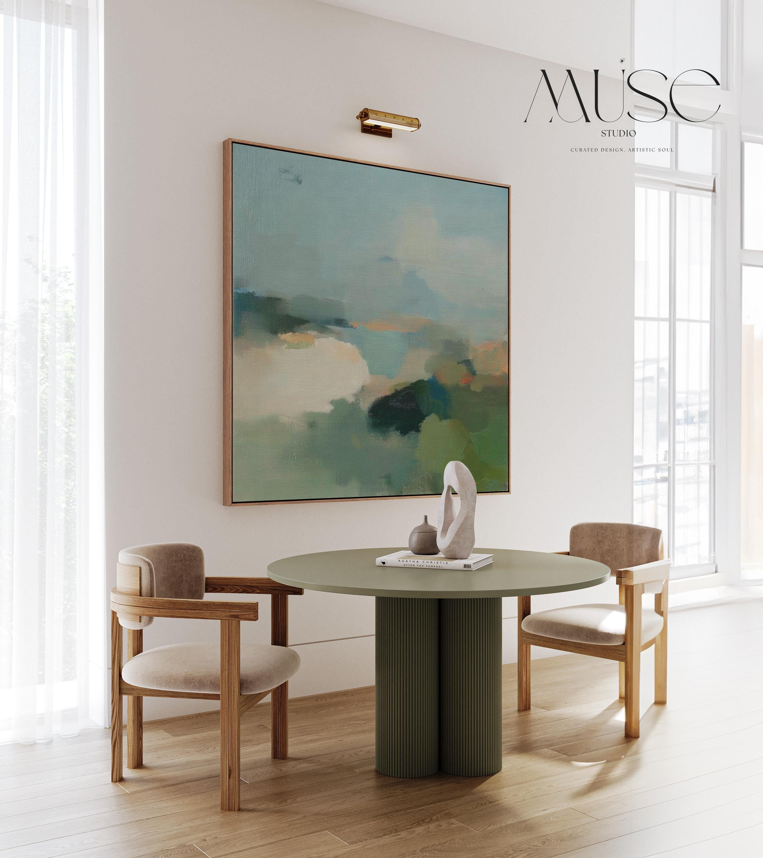 Square abstract wall art in sage green, soft blue, and muted neutrals with horizon-inspired brushstrokes. Large calming canvas decor designed for living rooms, bedrooms, or entryways. Styled for soft contemporary and nature-inspired interiors, perfect as a statement piece. Available as gallery-wrapped canvas, framed canvas, or fine art print.