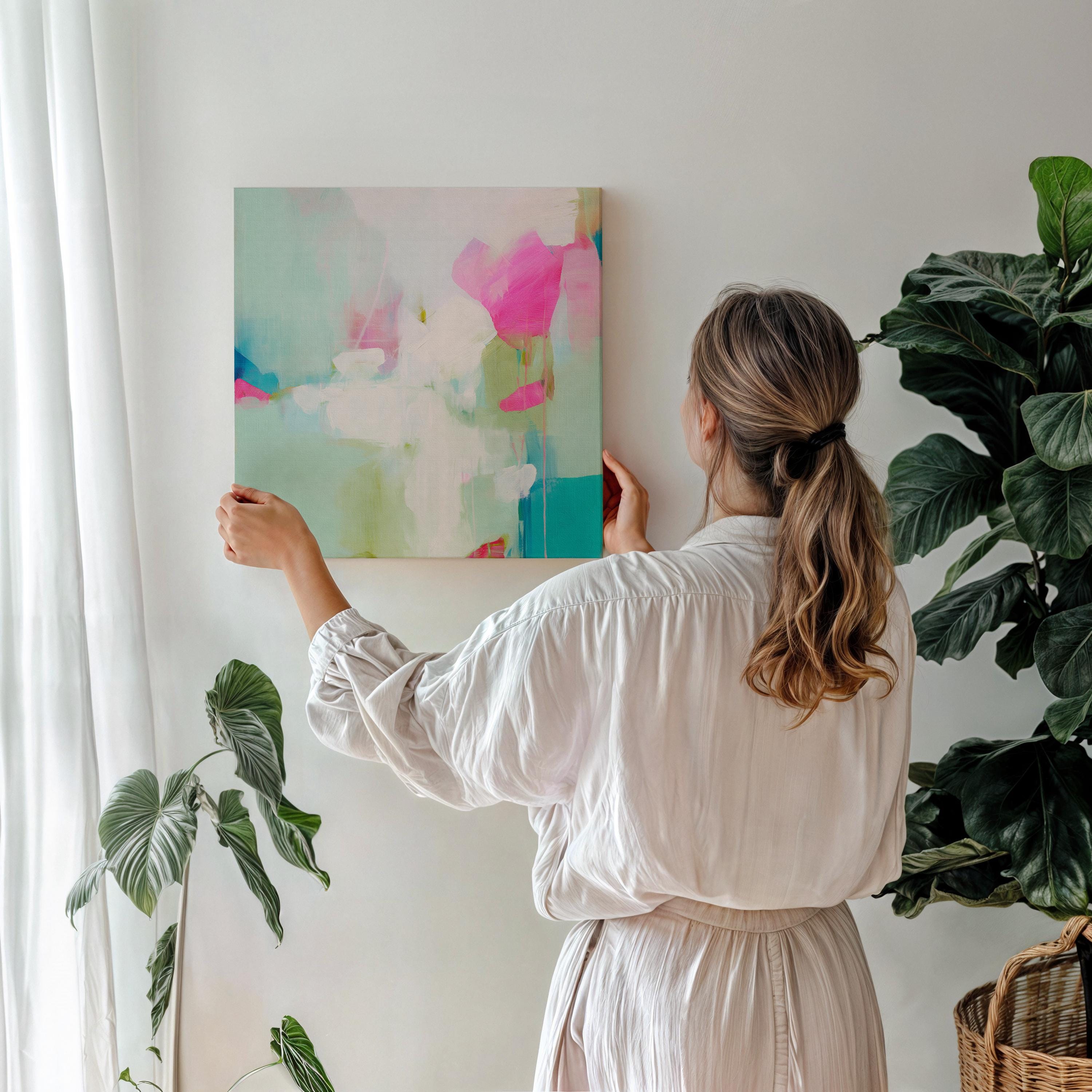 Square abstract wall art on canvas featuring aqua blue, blush pink, and soft white tones in a painterly pastel style. Designed for preppy and soft contemporary interiors, this large framed artwork brings an airy yet vibrant mood to bedrooms, nurseries, or living rooms. Available as a gallery-wrapped or framed canvas for curated designer decor.