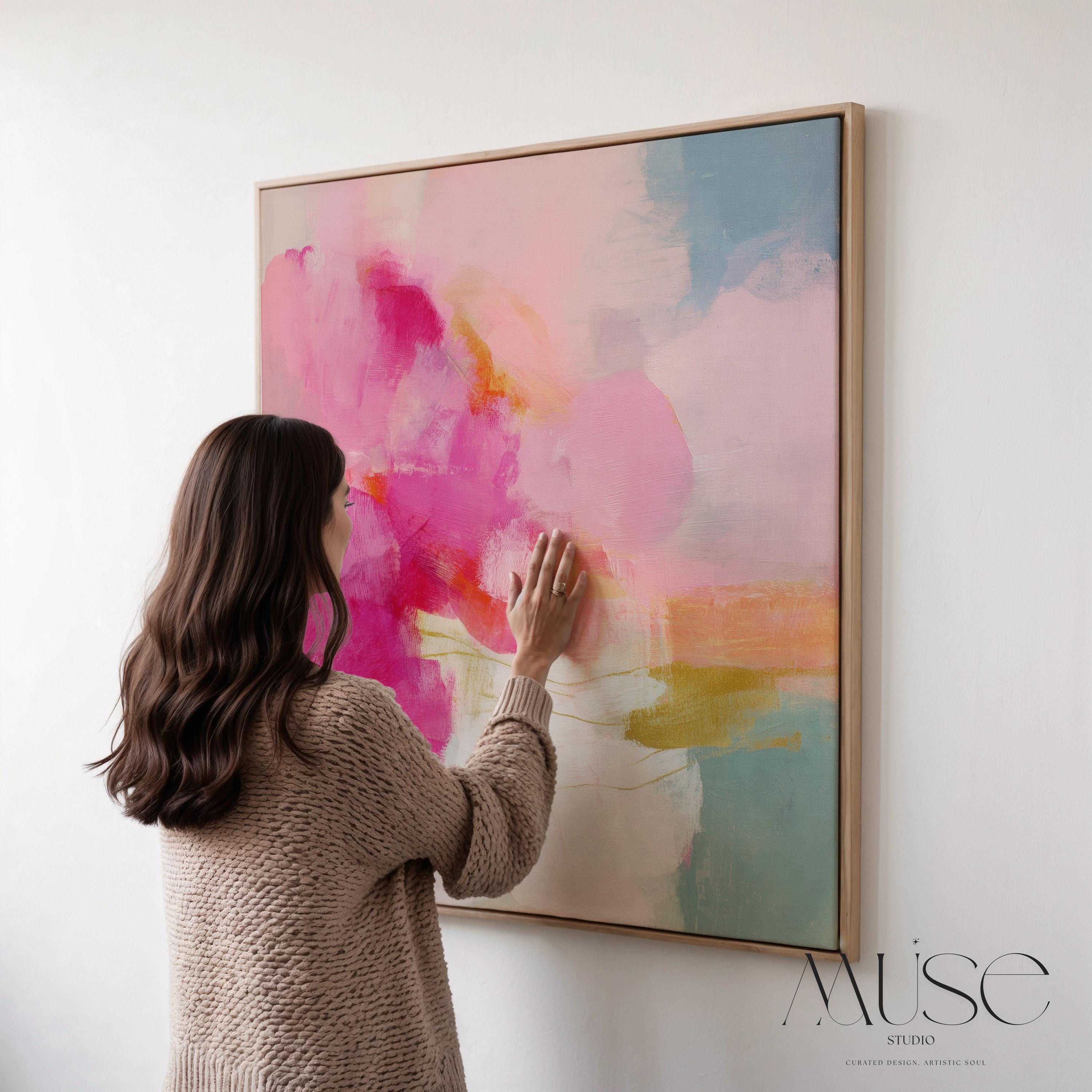 Framed square canvas wall art featuring bold pink and coral brushstrokes with teal and golden undertones. This abstract artwork blends boho, transitional, and soft contemporary design, perfect for bedrooms, living rooms, or entryway decor. Available as framed or gallery-wrapped canvas.