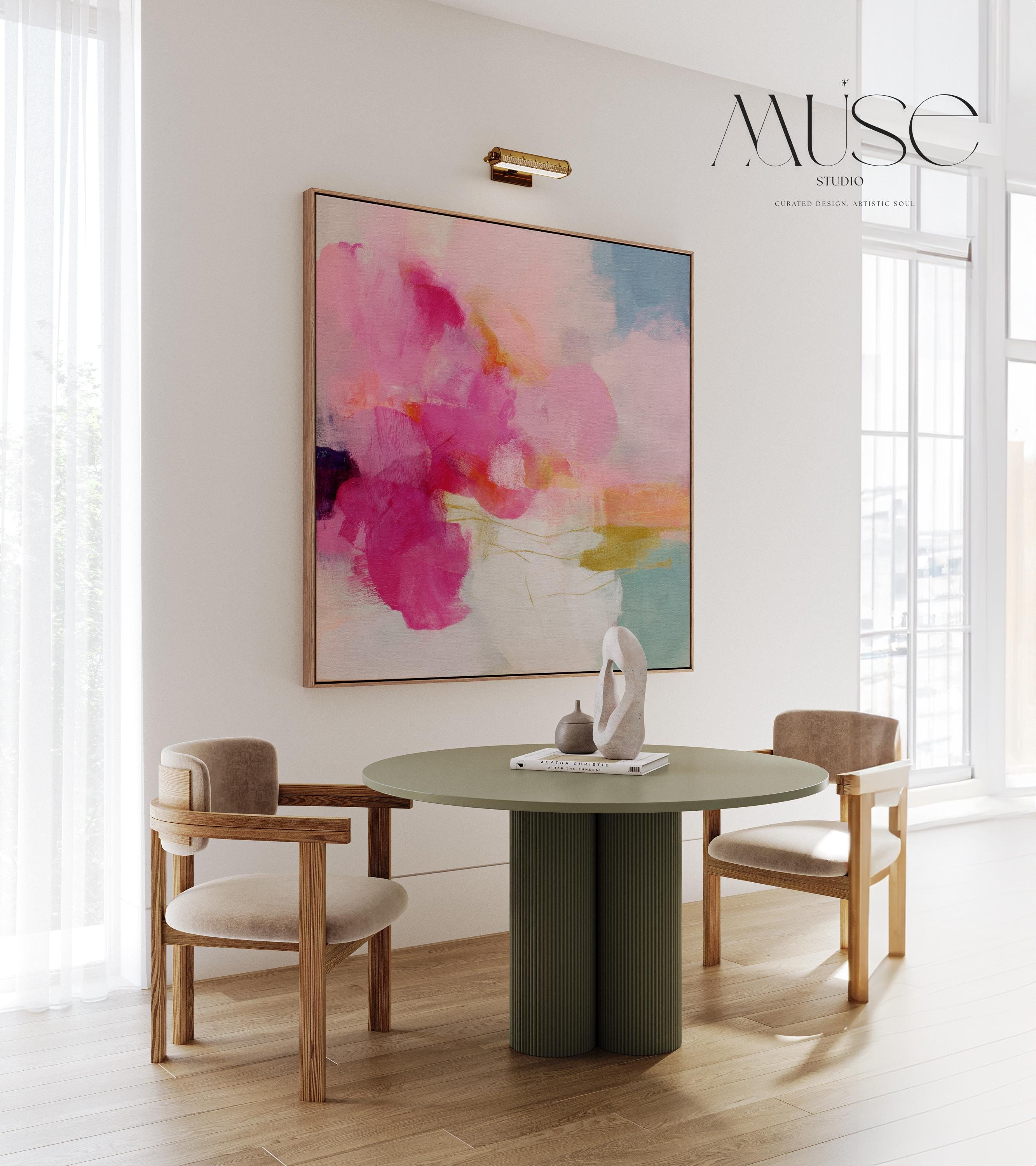 Framed square canvas wall art featuring bold pink and coral brushstrokes with teal and golden undertones. This abstract artwork blends boho, transitional, and soft contemporary design, perfect for bedrooms, living rooms, or entryway decor. Available as framed or gallery-wrapped canvas.