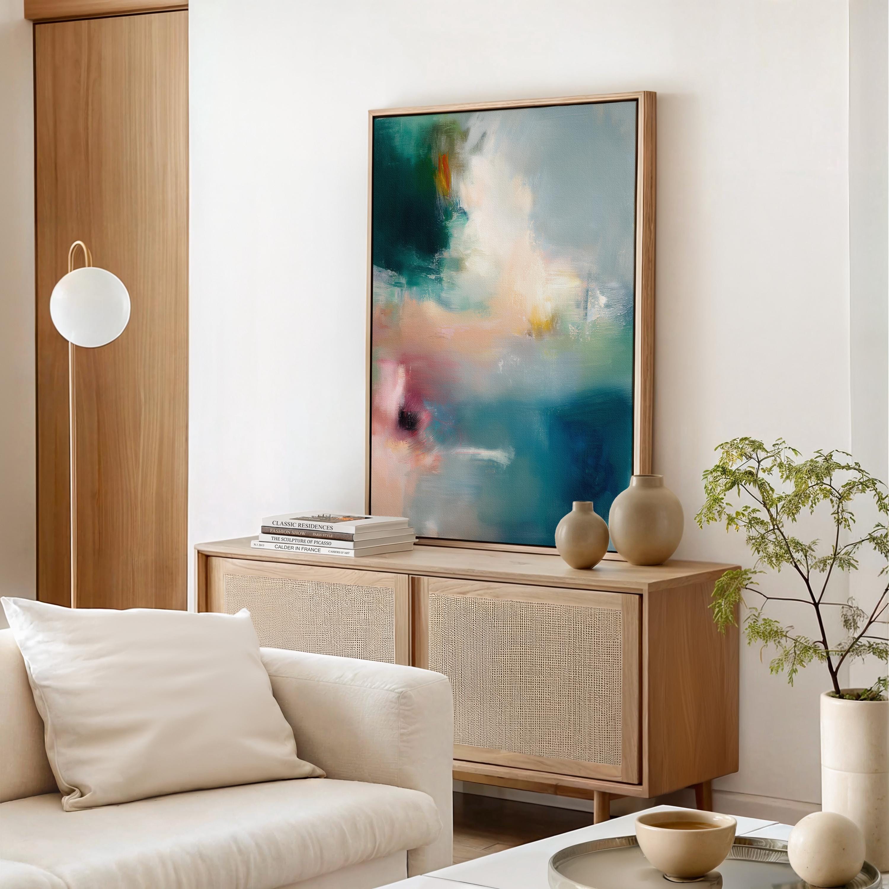 Vertical abstract canvas wall art featuring teal, blush, and gold tones with layered brushwork. The soft contemporary palette enhances modern and transitional interiors, ideal for bedrooms or living spaces. Available as a framed or gallery-wrapped canvas for designer-inspired decor.