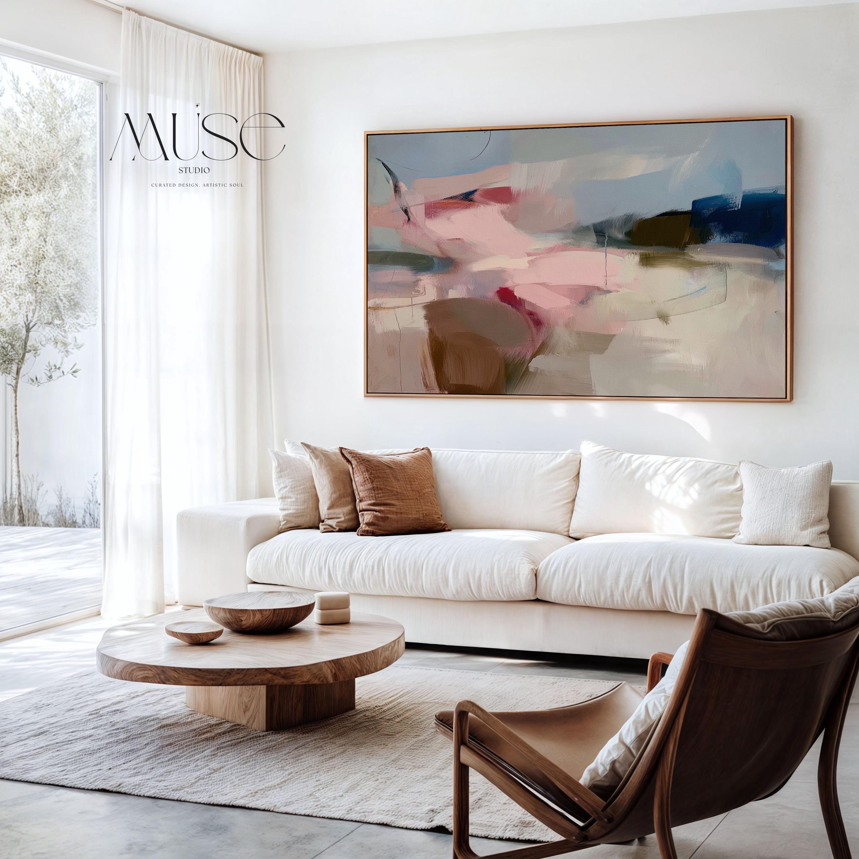 Horizontal abstract canvas wall art in soft blush, navy, and taupe tones with gentle painterly movement. The textured brushwork evokes warmth and calm, ideal for modern living rooms or bedrooms. Printed on premium cotton canvas, this gallery-wrapped piece arrives ready to hang for a clean, contemporary finish.