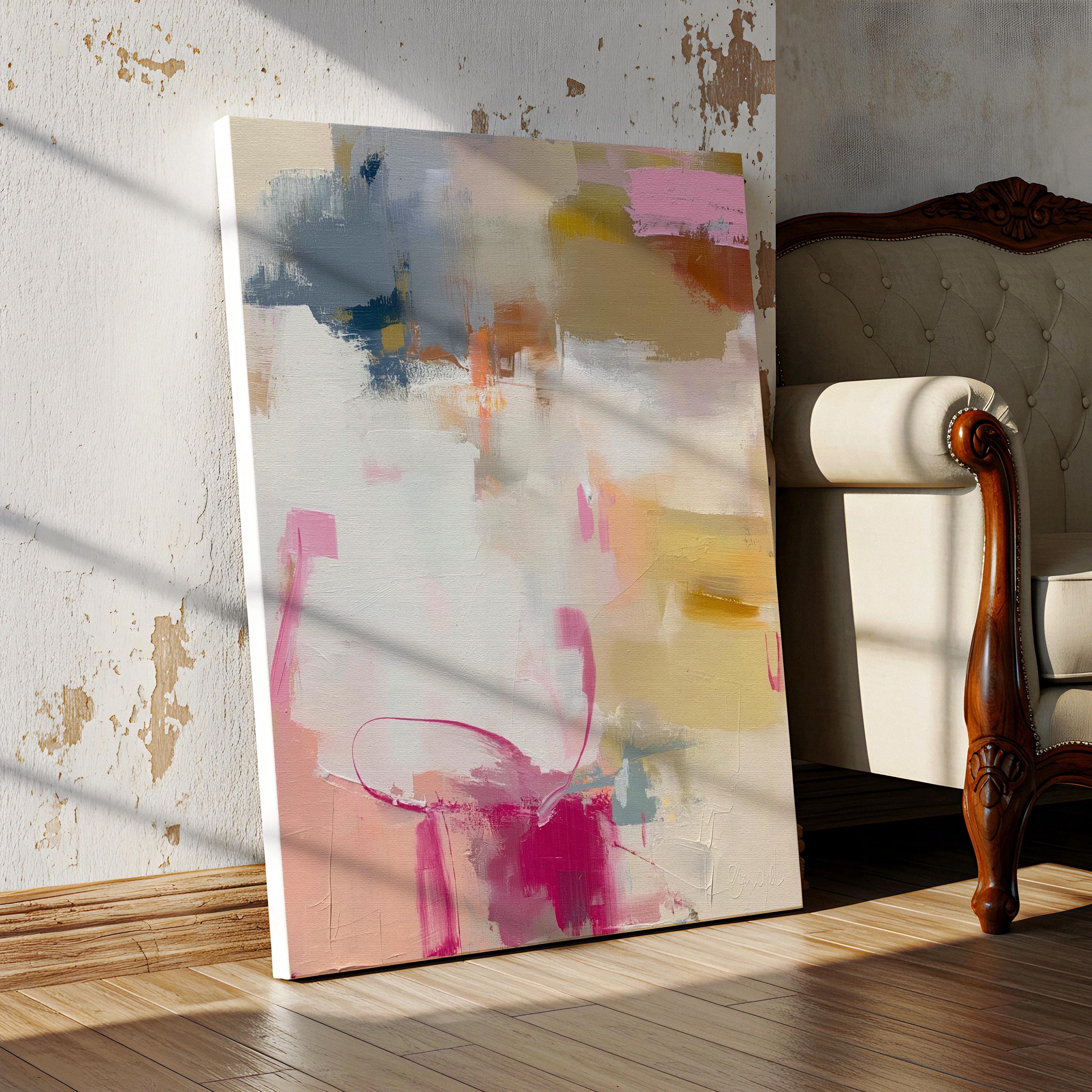 Vertical abstract canvas wall art featuring blush pink, gold, taupe, and soft blue hues in a soft contemporary color pop palette. The artwork adds warmth and elegance to modern interiors, perfect for living rooms, bedrooms, or entryways. Its layered brushwork and inviting tones create a sophisticated, designer look. Available as a gallery-wrapped canvas, framed canvas, or fine art poster print.