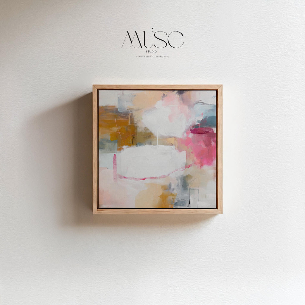 Square framed abstract wall art in pink, ochre, white, and teal tones with soft layered brushwork. The gentle interplay of warm and cool hues creates balance and light, ideal for pastel botanical or soft contemporary interiors. Perfect for living rooms, bedrooms, or studio spaces, this framed artwork features clean lines and a warm wood finish, ready to hang with a refined, gallery-style presentation.
