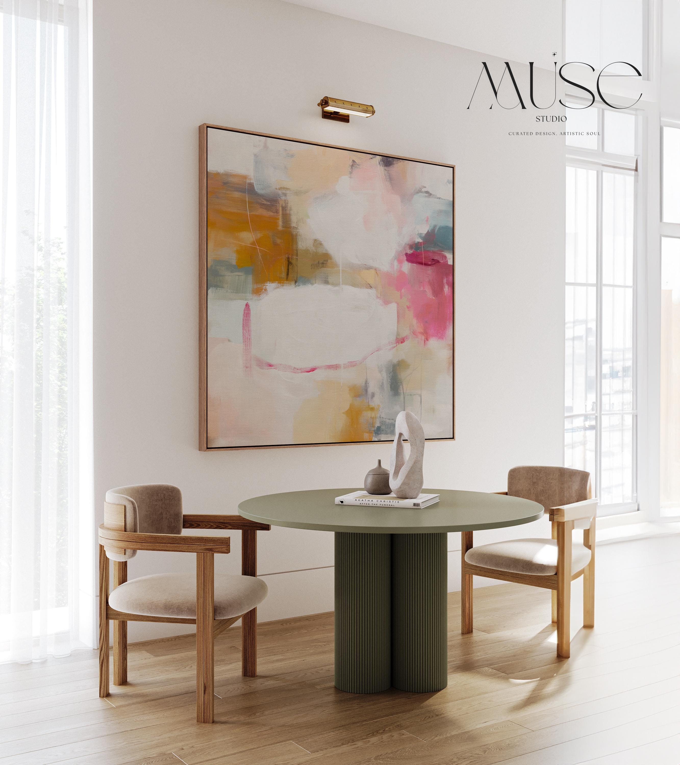 Square framed abstract wall art in pink, ochre, white, and teal tones with soft layered brushwork. The gentle interplay of warm and cool hues creates balance and light, ideal for pastel botanical or soft contemporary interiors. Perfect for living rooms, bedrooms, or studio spaces, this framed artwork features clean lines and a warm wood finish, ready to hang with a refined, gallery-style presentation.