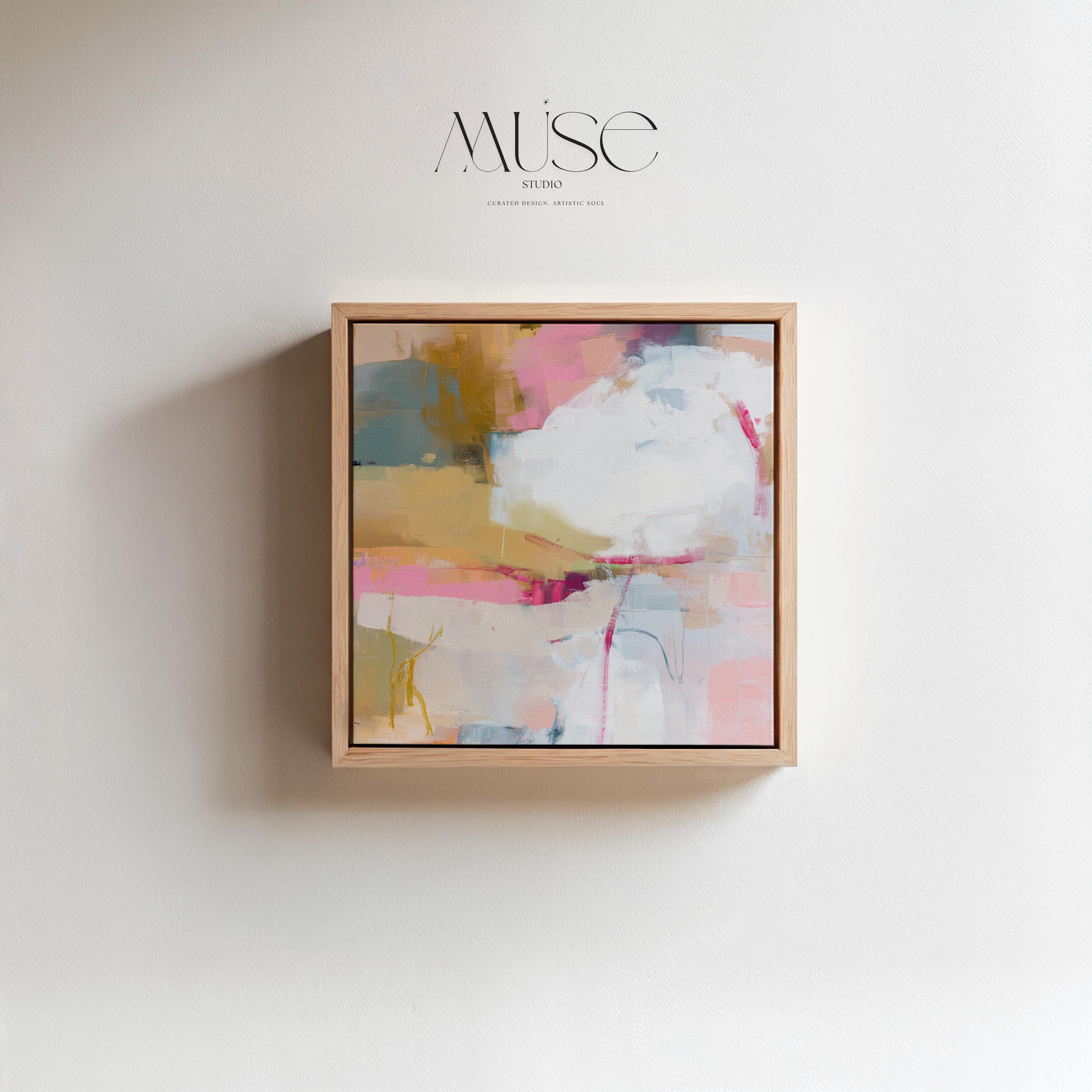 Square abstract wall art in soft pink, mustard, white, and teal tones framed in natural wood and displayed on a clean white wall. Light pastel contemporary artwork with gentle brushwork, ideal for modern living rooms, bedrooms, or designer interiors. Available as framed canvas or giclée print by Muse Studio.