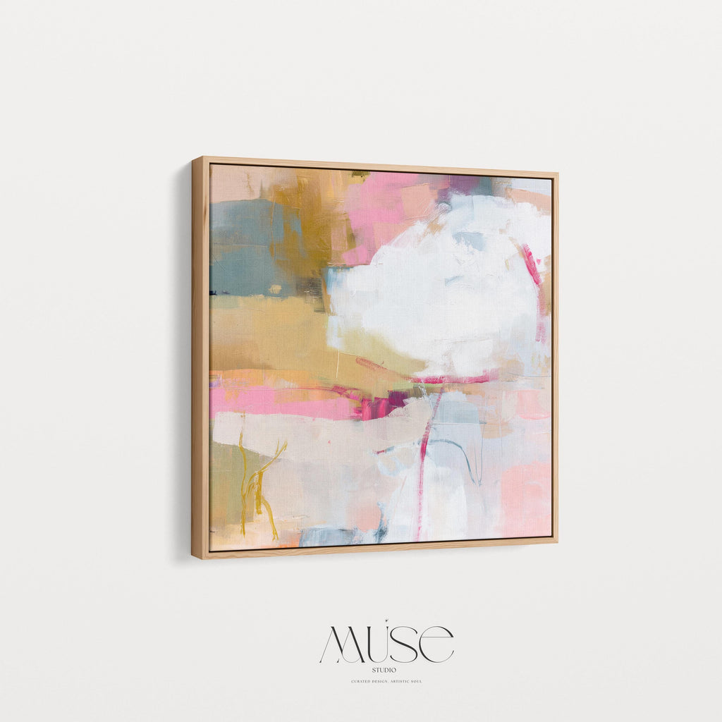 Square abstract wall art in soft pink, mustard, white, and teal tones framed in natural wood and displayed on a clean white wall. Light pastel contemporary artwork with gentle brushwork, ideal for modern living rooms, bedrooms, or designer interiors. Available as framed canvas or giclée print by Muse Studio.