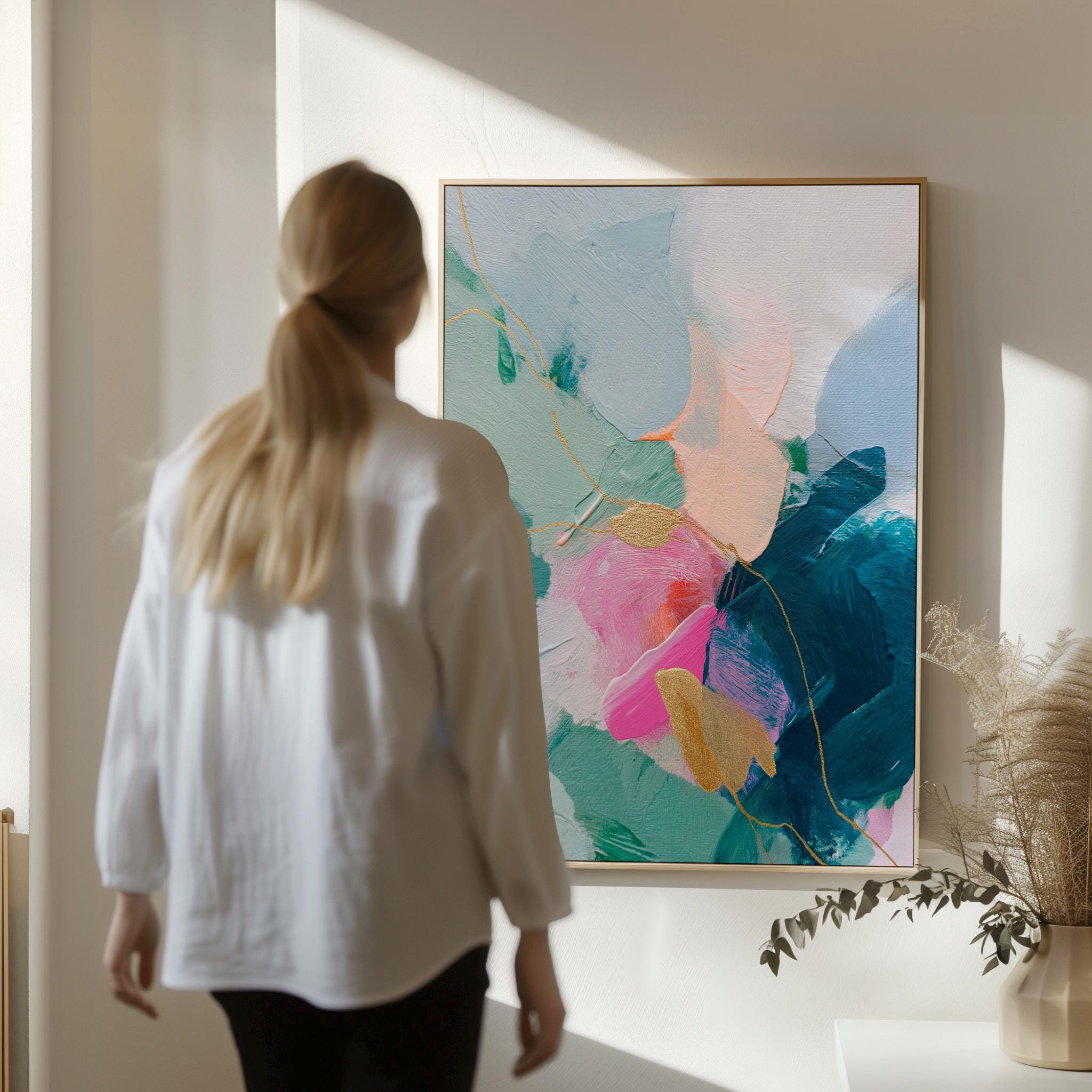 Vertical abstract canvas wall art featuring teal, blush pink, and gold accents with layered brush texture. Designed for transitional and modern interiors, this piece enhances bedrooms, hallways, or living rooms. Available framed or as a gallery-wrapped canvas for curated, designer-forward decor.
