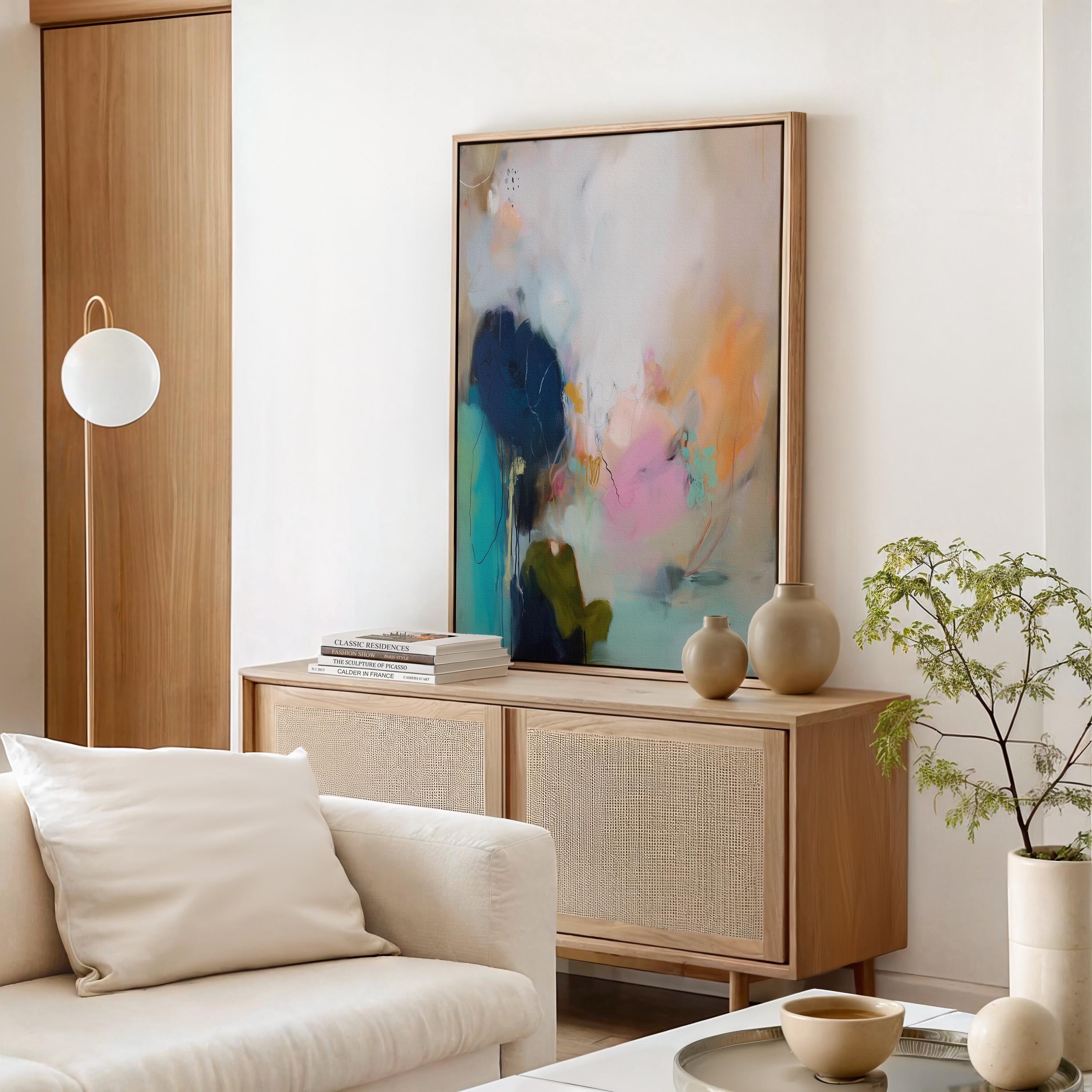 ertical abstract canvas wall art featuring teal, blush, and peach brushstrokes with soft white layers. The composition exudes modern warmth and calm movement, perfect for living rooms, bedrooms, or transitional interiors. Available as a large gallery-wrapped canvas in premium cotton for a refined, designer-quality finish.