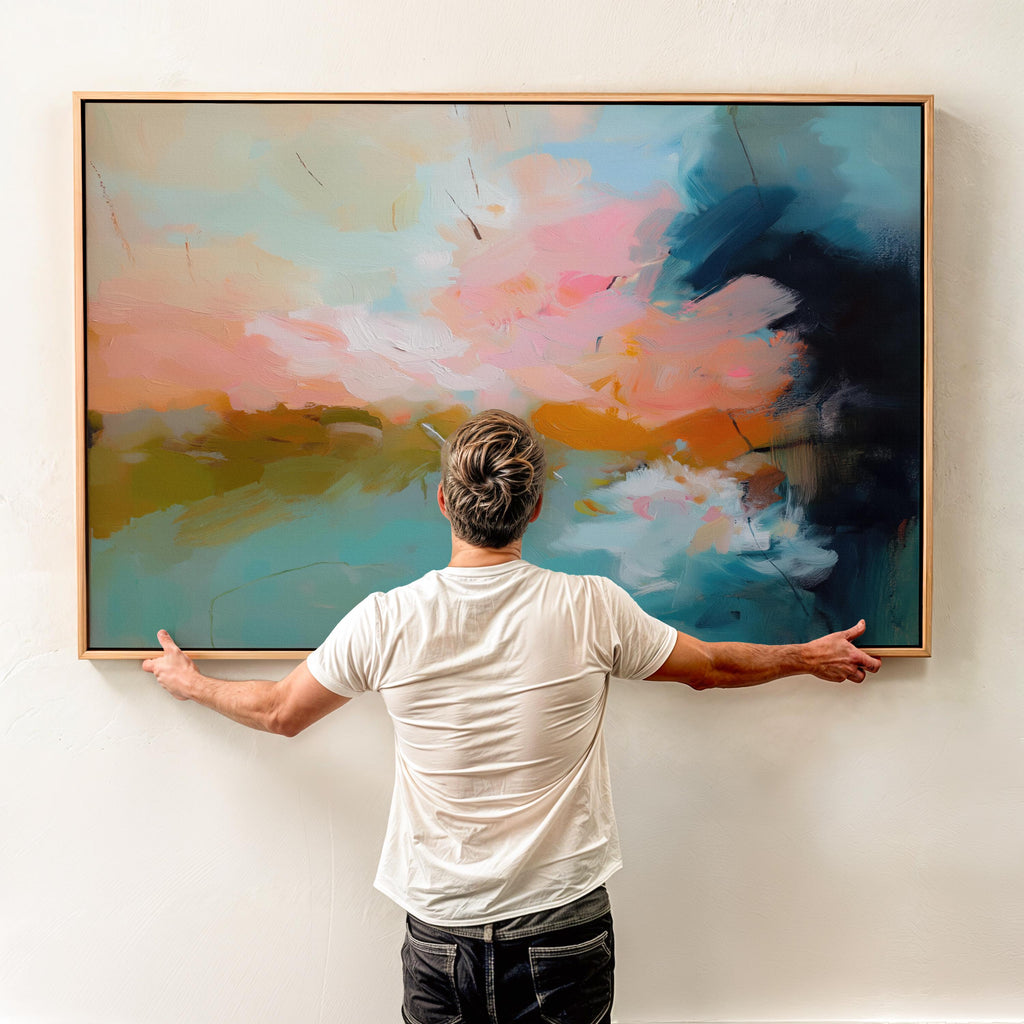 Horizontal framed abstract artwork featuring soft turquoise, peach, and gold tones inspired by ocean horizons. Ideal for Coastal Horizon interiors, this piece brings calm energy and warmth to living rooms, beach houses, or modern spaces. Printed on archival cotton-blend canvas, hand-stretched, and framed in natural wood for a refined, gallery-quality finish.