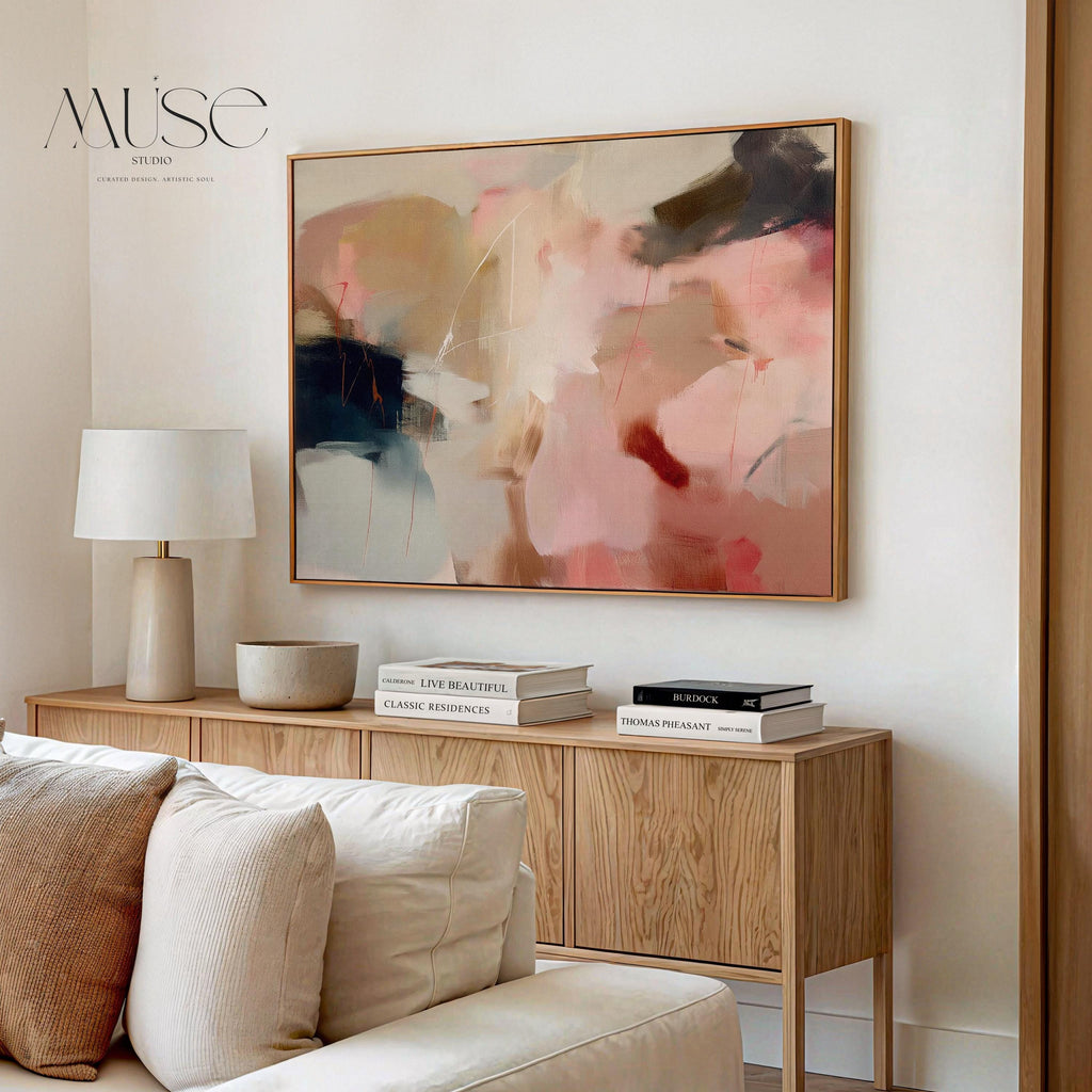 Horizontal abstract wall art in blush pink, beige, and navy tones framed in natural wood. This soft contemporary design blends fluid movement with a calm, elegant palette—ideal for warm minimalist or transitional interiors. Perfect for living rooms, bedrooms, or entryways seeking refined, serene decor. Available as a framed canvas wall art, gallery-wrapped canvas, or fine art poster print.