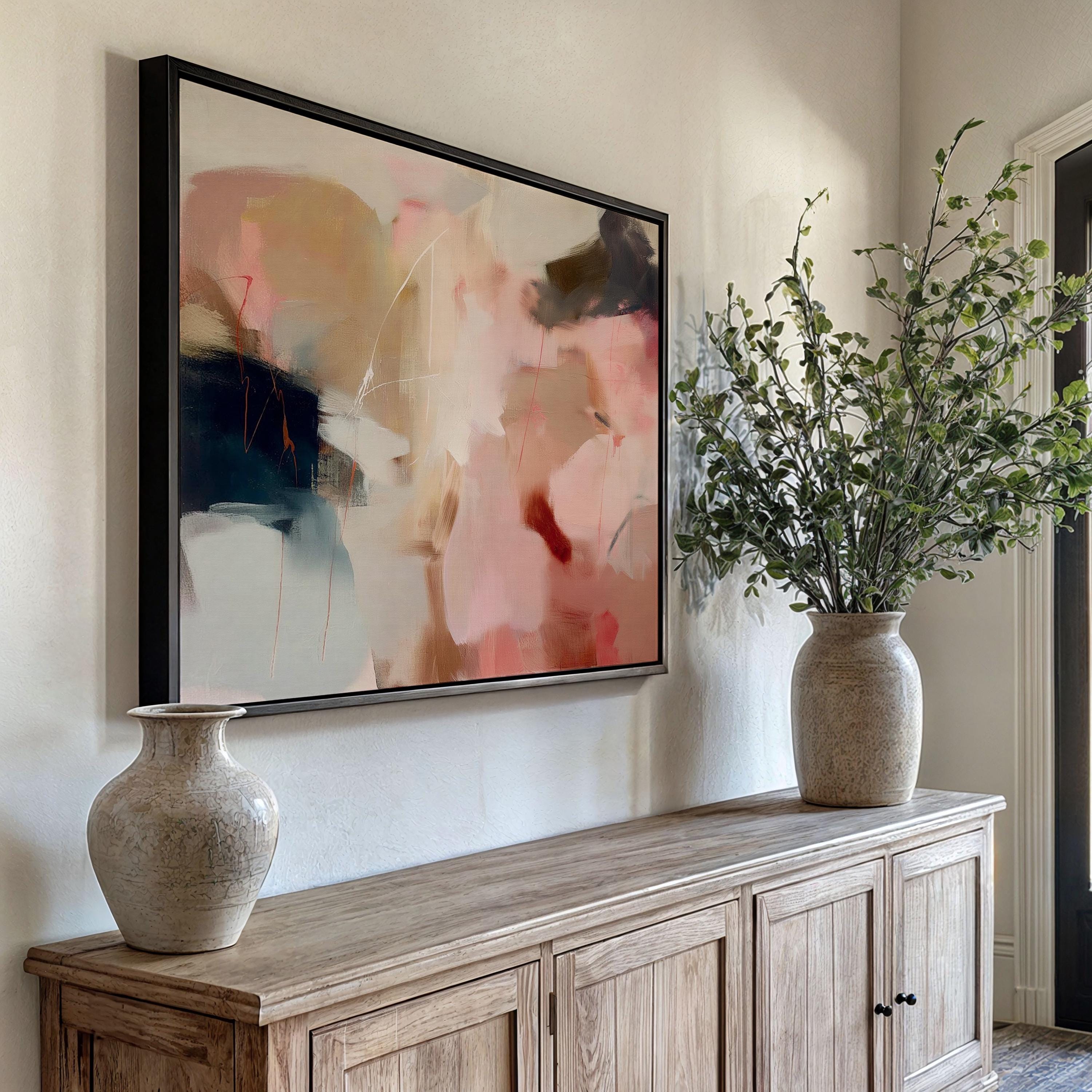 Horizontal abstract wall art in blush pink, beige, and navy tones framed in natural wood. This soft contemporary design blends fluid movement with a calm, elegant palette—ideal for warm minimalist or transitional interiors. Perfect for living rooms, bedrooms, or entryways seeking refined, serene decor. Available as a framed canvas wall art, gallery-wrapped canvas, or fine art poster print.