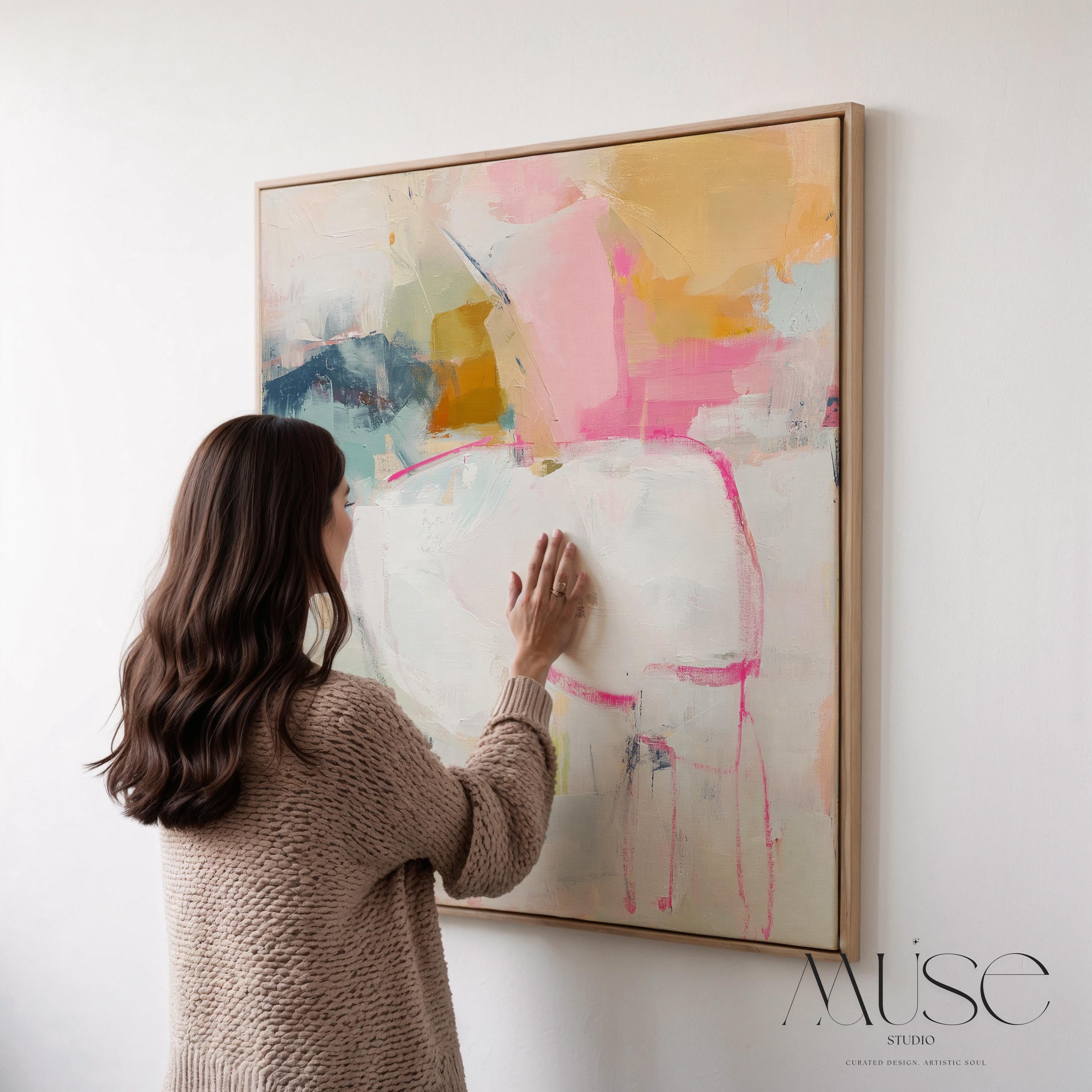 Square framed abstract wall art featuring soft pink, white, aqua, and golden tones. Gentle brushstrokes create an airy, serene atmosphere perfect for pastel botanical or soft contemporary interiors. Ideal for bedrooms, living rooms, or home offices. The warm wood frame adds a refined designer touch, ready to hang and finished for a clean, gallery-style look. Available as framed canvas, gallery-wrapped canvas, or fine art poster print.