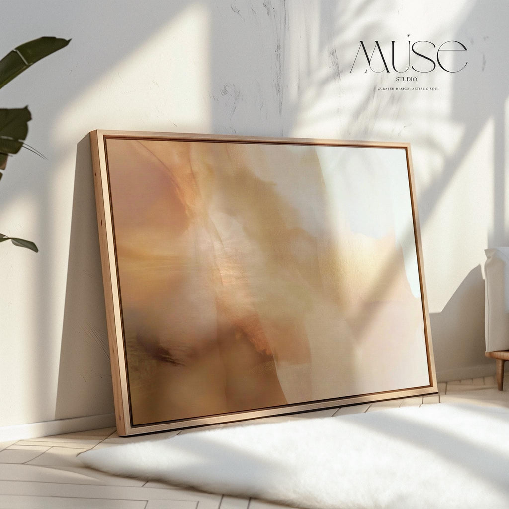 Horizontal warm-neutral abstract wall art in beige, sand, and ivory tones, styled in a warm minimal interior with light wood and linen textures. Available as framed canvas or gallery canvas by Muse Studio.
