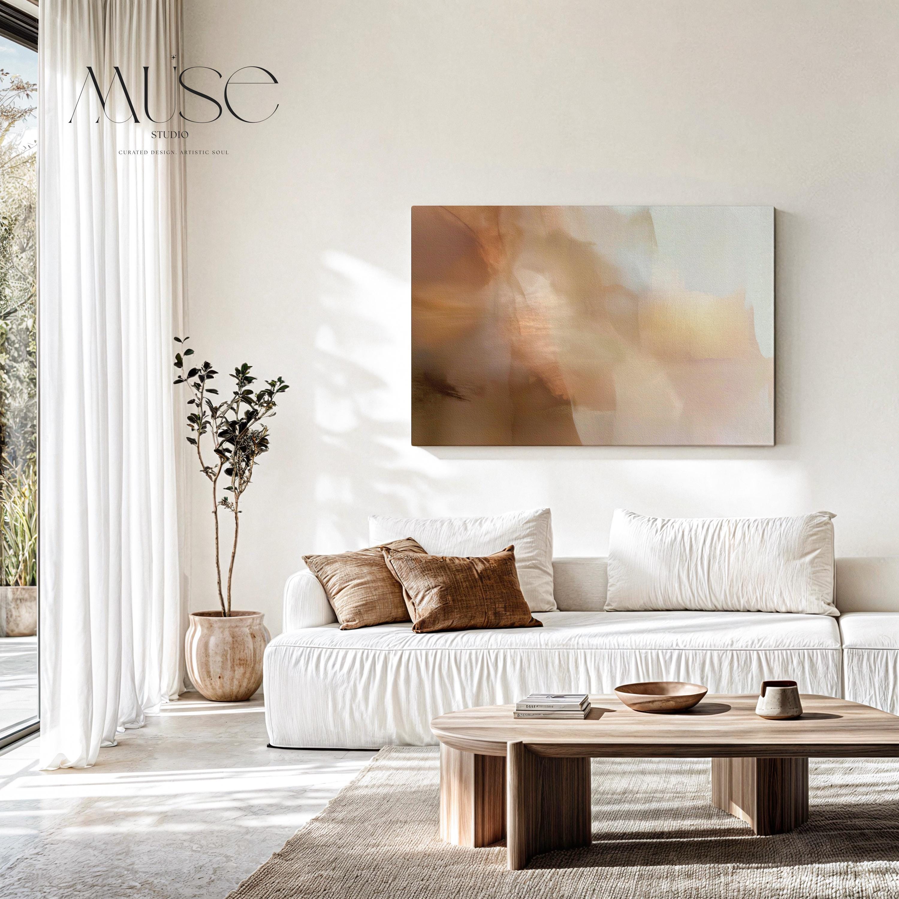 Horizontal warm-neutral abstract wall art in beige, sand, and ivory tones, styled in a warm minimal interior with light wood and linen textures. Available as framed canvas or gallery canvas by Muse Studio.