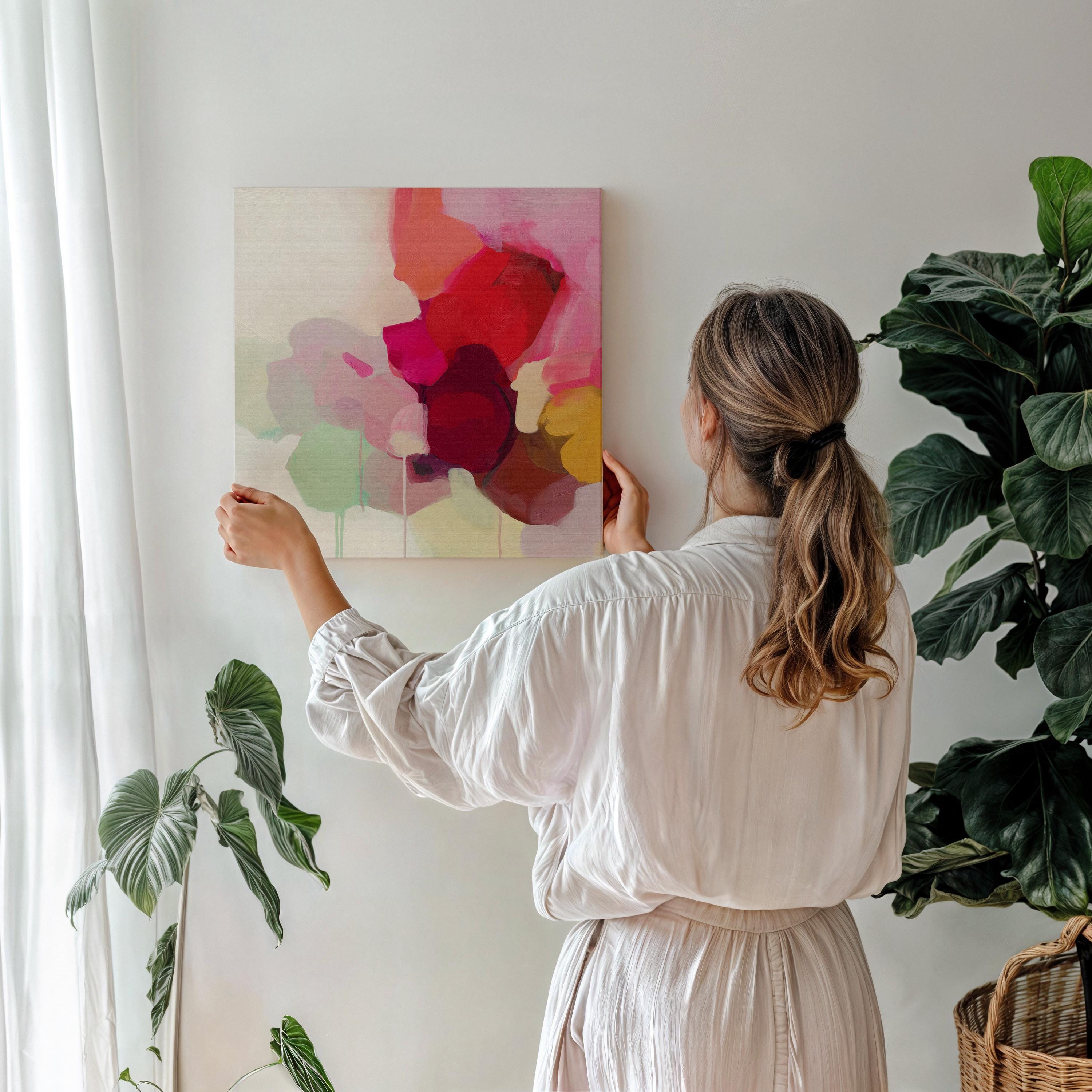 Large square abstract wall art featuring crimson, rose, plum, and soft green tones. This vibrant piece blends fluid color transitions with expressive brushwork, perfect for Color Pop or Soft Contemporary interiors. Ideal for living rooms or creative spaces. Gallery-wrapped canvas wall art with a fine-textured surface, ready to hang and infuse any room with bold, joyful color.