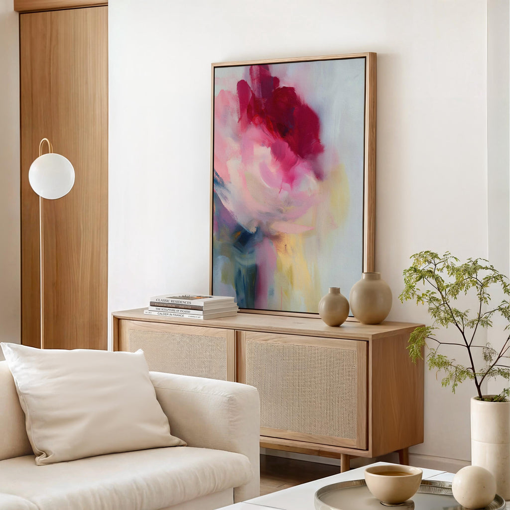Vertical abstract wall art in soft pink, rose, and misty blue tones, blending painterly layers with an airy, luminous finish. Ideal for bedrooms or entryways, this soft contemporary design adds tranquility and subtle color. Floater framed in FSC-certified wood with a natural finish, printed on archival cotton-blend canvas for premium wall decor.