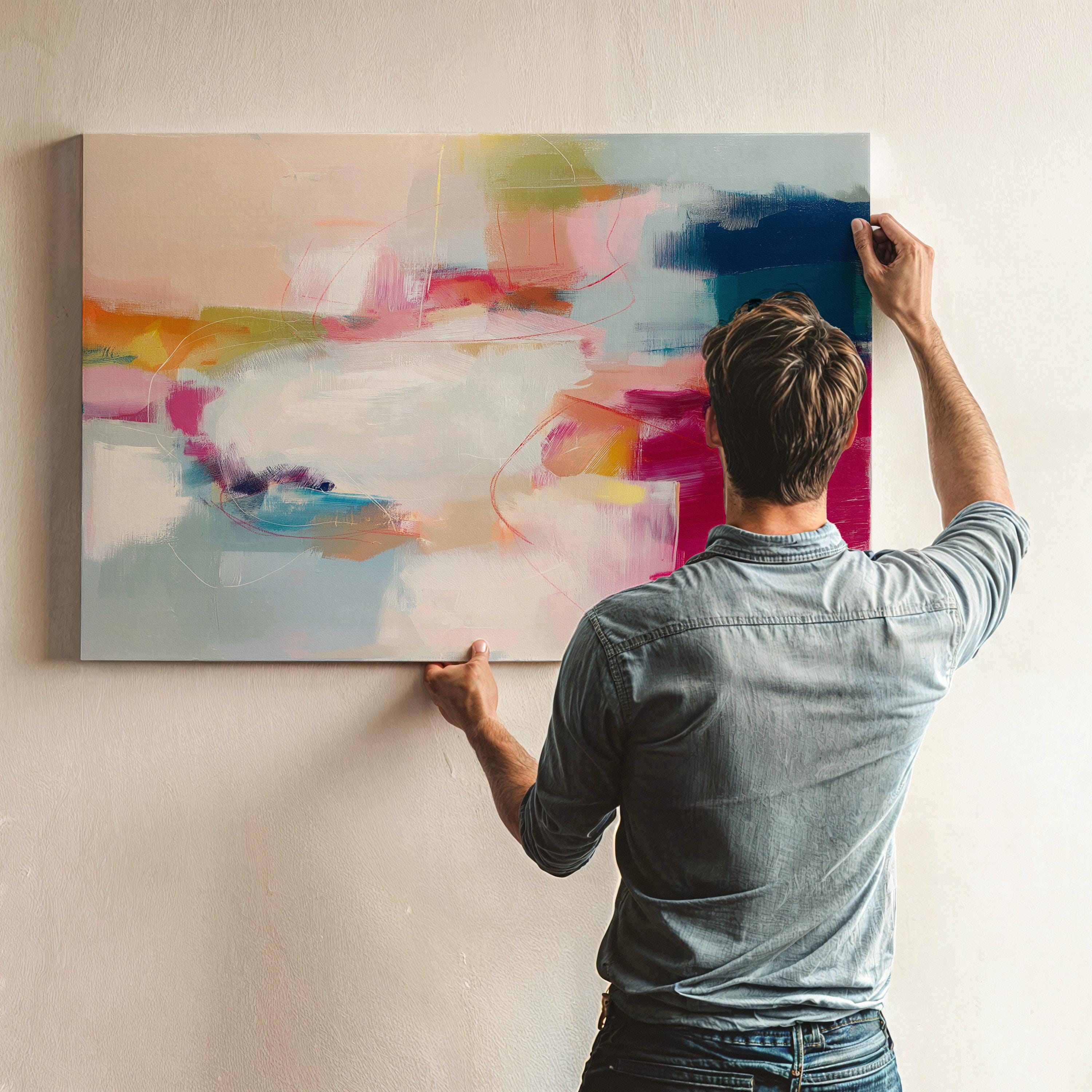 Horizontal abstract canvas artwork in shades of blush pink, soft gold, and muted blue with painterly layers and gentle movement. Ideal for Soft Contemporary interiors, this design brings calm vibrancy to living rooms, offices, or curated spaces. Printed on archival cotton-blend canvas and hand-stretched for a gallery-quality finish with modern appeal.