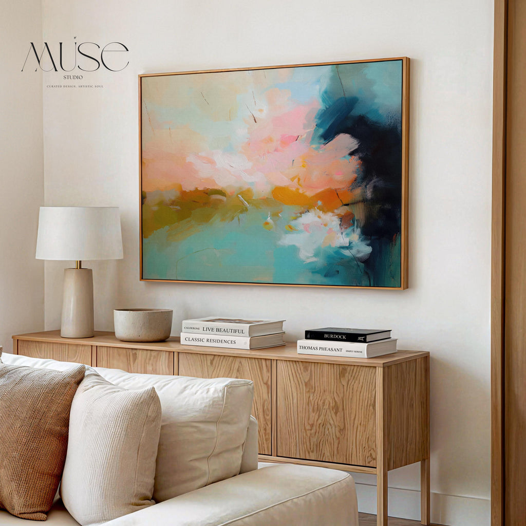 Horizontal framed abstract artwork featuring soft turquoise, peach, and gold tones inspired by ocean horizons. Ideal for Coastal Horizon interiors, this piece brings calm energy and warmth to living rooms, beach houses, or modern spaces. Printed on archival cotton-blend canvas, hand-stretched, and framed in natural wood for a refined, gallery-quality finish.