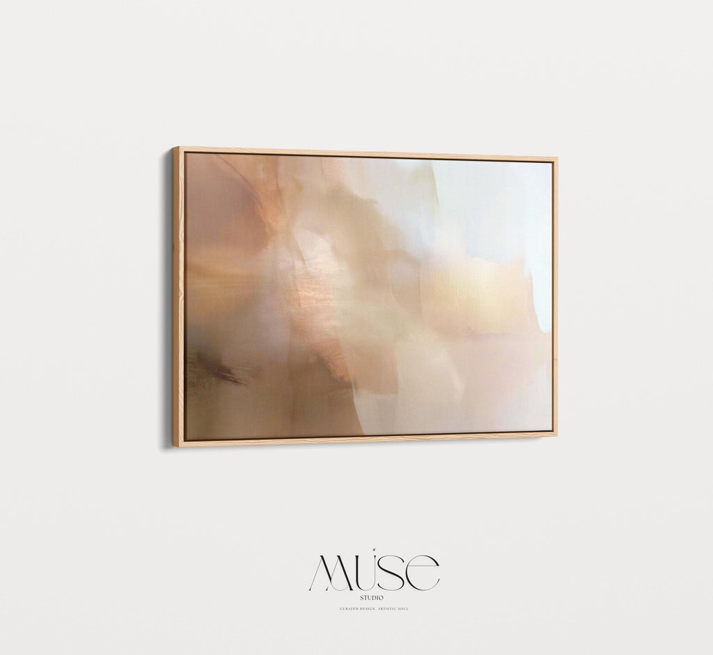 Horizontal warm-neutral abstract wall art in beige, sand, and ivory tones, styled in a warm minimal interior with light wood and linen textures. Available as framed canvas or gallery canvas by Muse Studio.