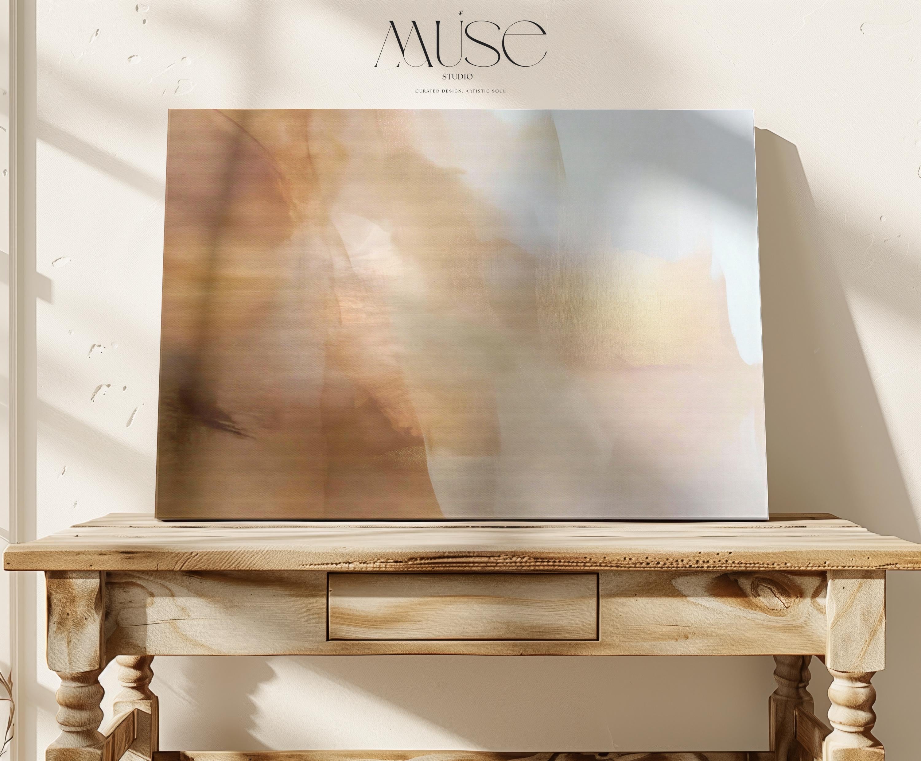 Horizontal warm-neutral abstract wall art in beige, sand, and ivory tones, styled in a warm minimal interior with light wood and linen textures. Available as framed canvas or gallery canvas by Muse Studio.