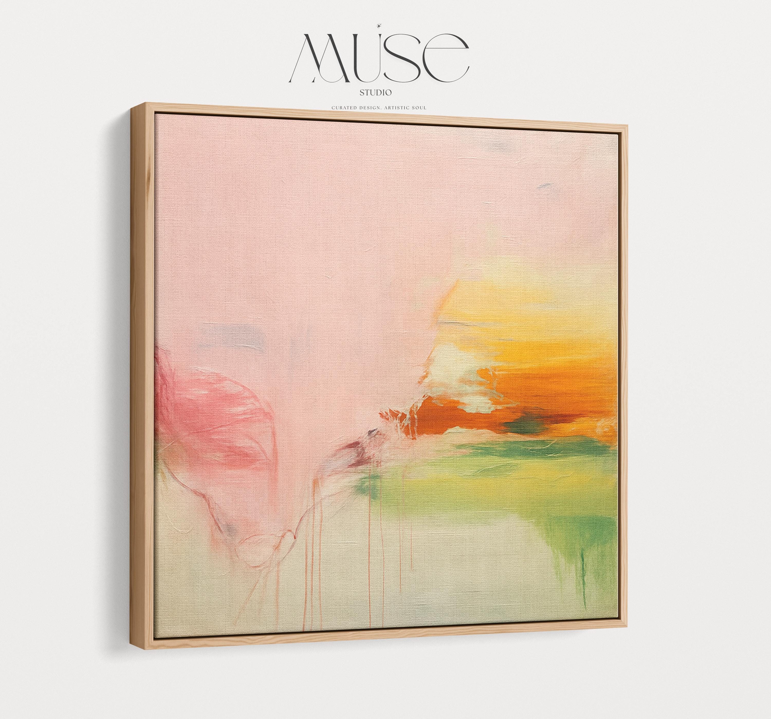 Square abstract wall art in blush pink, soft peach, golden ochre, and fresh green tones, featuring gentle painterly blends and subtle drips. Styled in a natural wood floater frame, the piece reflects soft contemporary and warm minimal design, ideal for bedrooms, living rooms, or calming modern interiors. Gallery-wrapped framed canvas by Muse Studio.