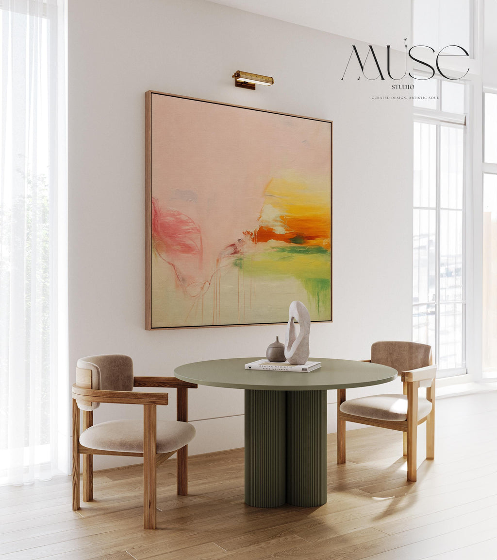 Square abstract wall art in blush pink, soft peach, golden ochre, and fresh green tones, featuring gentle painterly blends and subtle drips. Styled in a natural wood floater frame, the piece reflects soft contemporary and warm minimal design, ideal for bedrooms, living rooms, or calming modern interiors. Gallery-wrapped framed canvas by Muse Studio.