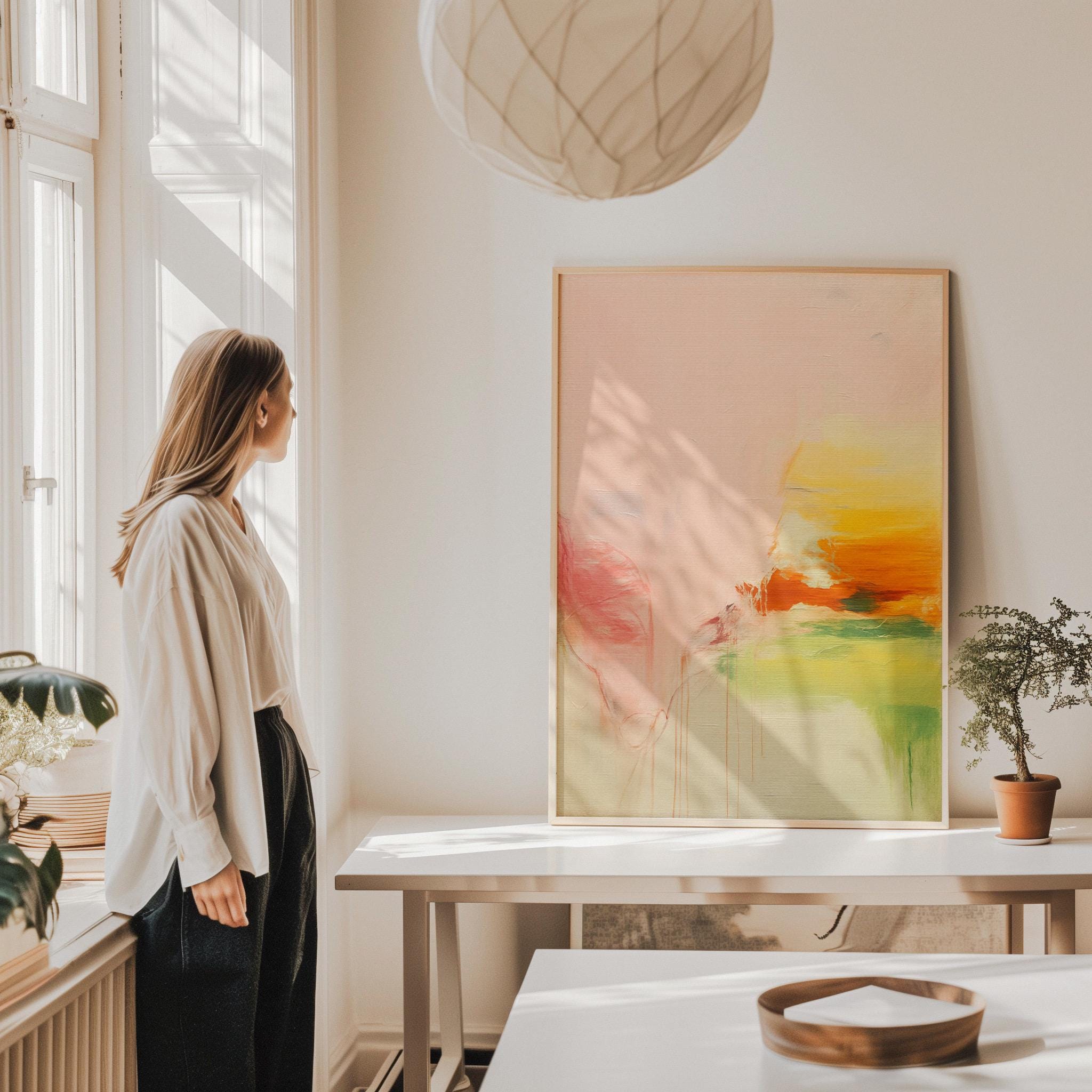 Soft pastel muted abstract wall art featuring blush, peach, and golden tones with gentle blended texture. Ideal for calm modern interiors, bedrooms, wellness spaces, or neutral pastel décor. Available as framed wall art, gallery canvas, or fine art giclée print by Muse Studio.