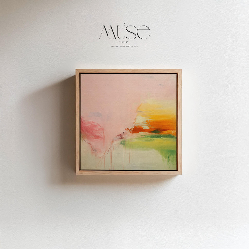 Square abstract wall art in blush pink, soft peach, golden ochre, and fresh green tones, featuring gentle painterly blends and subtle drips. Styled in a natural wood floater frame, the piece reflects soft contemporary and warm minimal design, ideal for bedrooms, living rooms, or calming modern interiors. Gallery-wrapped framed canvas by Muse Studio.