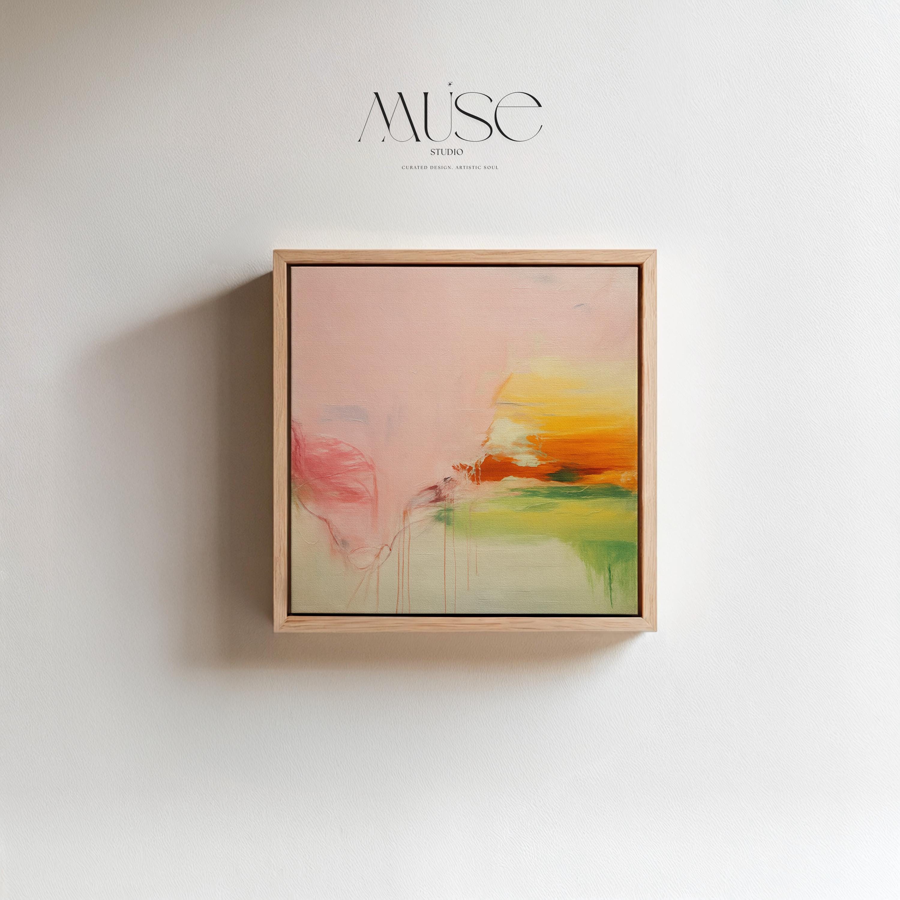 Square abstract wall art in blush pink, soft peach, golden ochre, and fresh green tones, featuring gentle painterly blends and subtle drips. Styled in a natural wood floater frame, the piece reflects soft contemporary and warm minimal design, ideal for bedrooms, living rooms, or calming modern interiors. Gallery-wrapped framed canvas by Muse Studio.