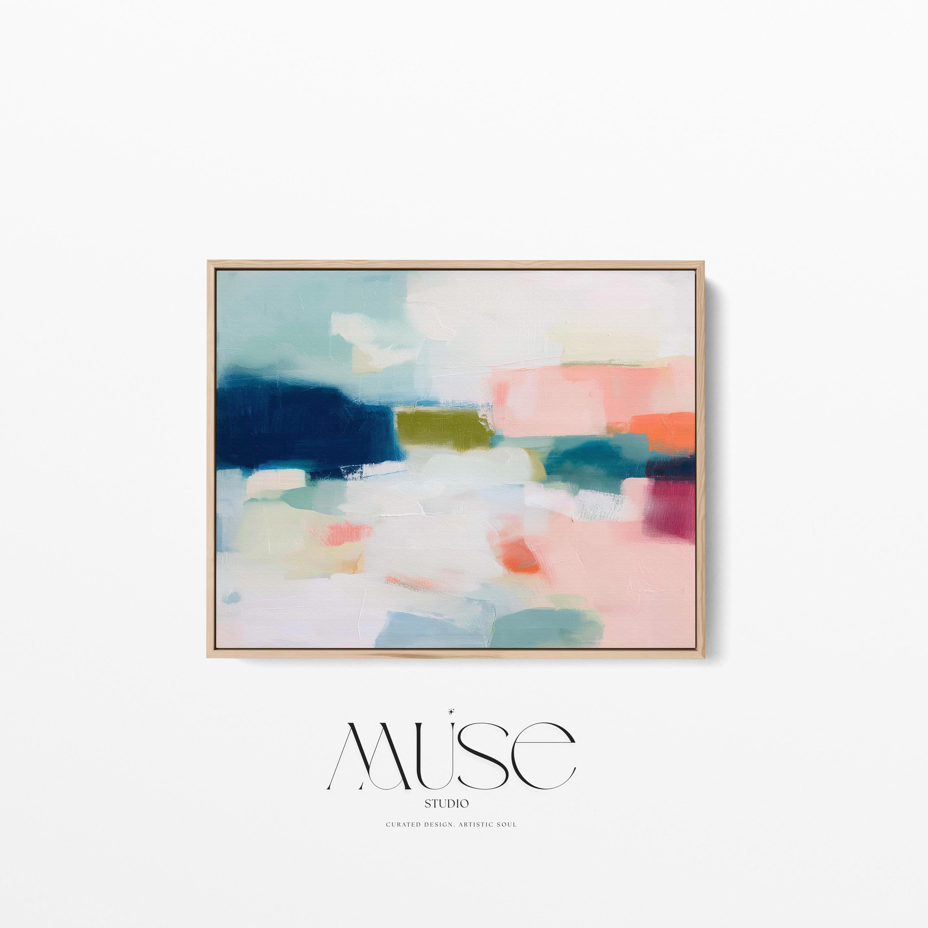Large horizontal abstract framed canvas wall art featuring deep navy blue, muted aqua, soft blush pink, olive green, coral accents, and layered white brushstrokes, styled above a neutral sofa in a modern coastal living room, offering balanced contrast and refined contemporary color.