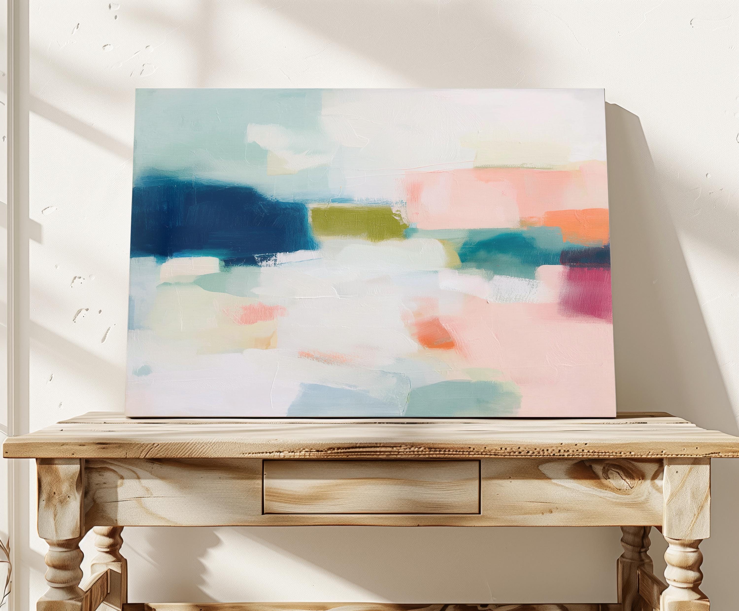 Large horizontal abstract canvas wall art featuring navy blue, muted aqua, blush pink, olive green, and coral tones layered across a soft white background, designed for above couch placement in a modern coastal living room, offering rich contrast and contemporary warmth.