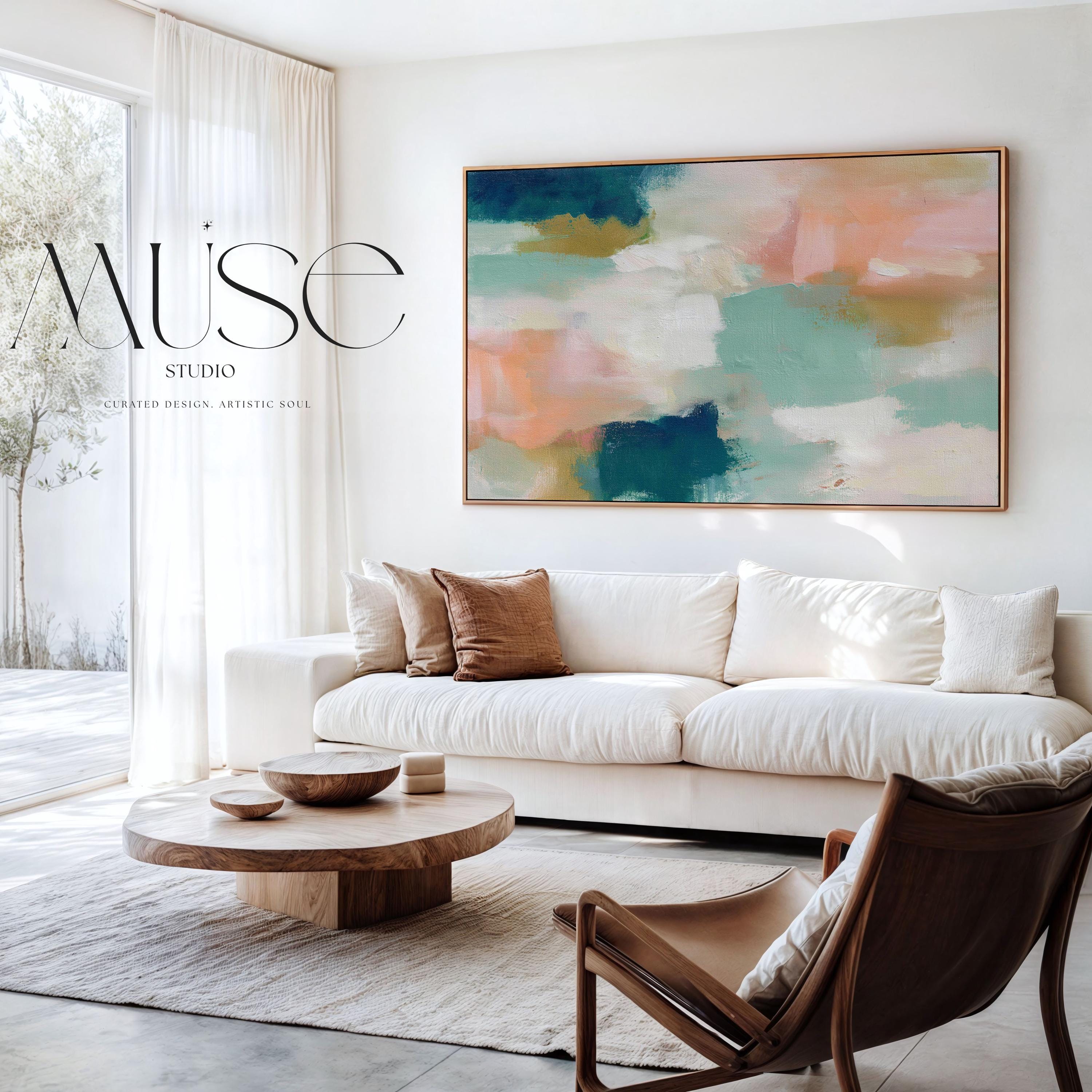 Large horizontal abstract canvas wall art featuring teal blue, mint green, soft peach, and warm sand tones layered over cream, designed for above couch placement, bringing airy color balance and painterly texture to a living room or bedroom wall.