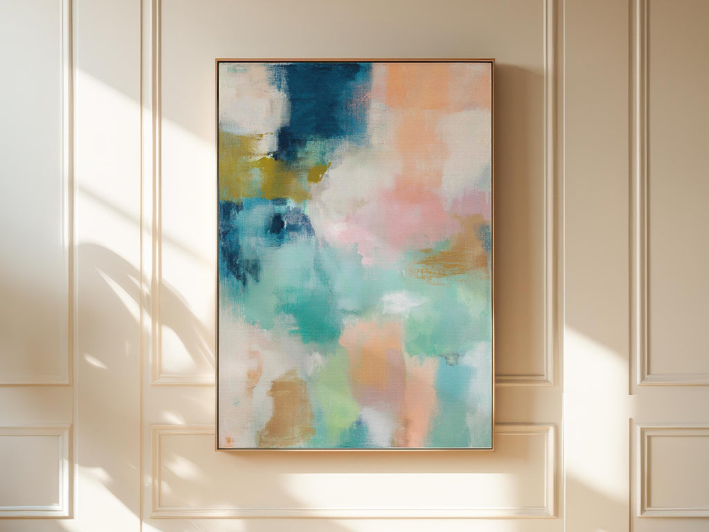 Large vertical abstract framed canvas wall art featuring layered teal, soft peach, cream, blush, and muted gold tones, styled for a serene bedroom or above a console table, offering coastal warmth and quiet luxury in a tall modern interior.