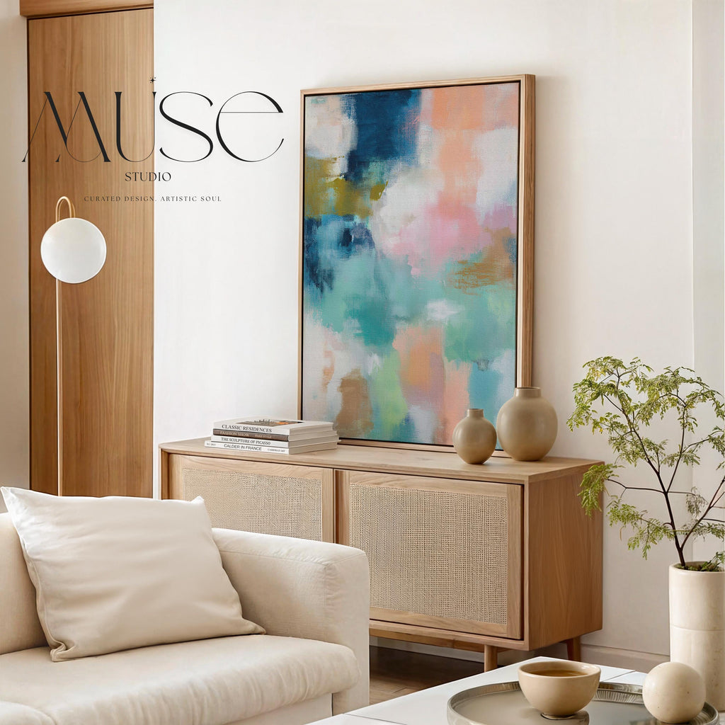 Large vertical abstract framed canvas wall art featuring layered teal, soft peach, cream, blush, and muted gold tones, styled for a serene bedroom or above a console table, offering coastal warmth and quiet luxury in a tall modern interior.