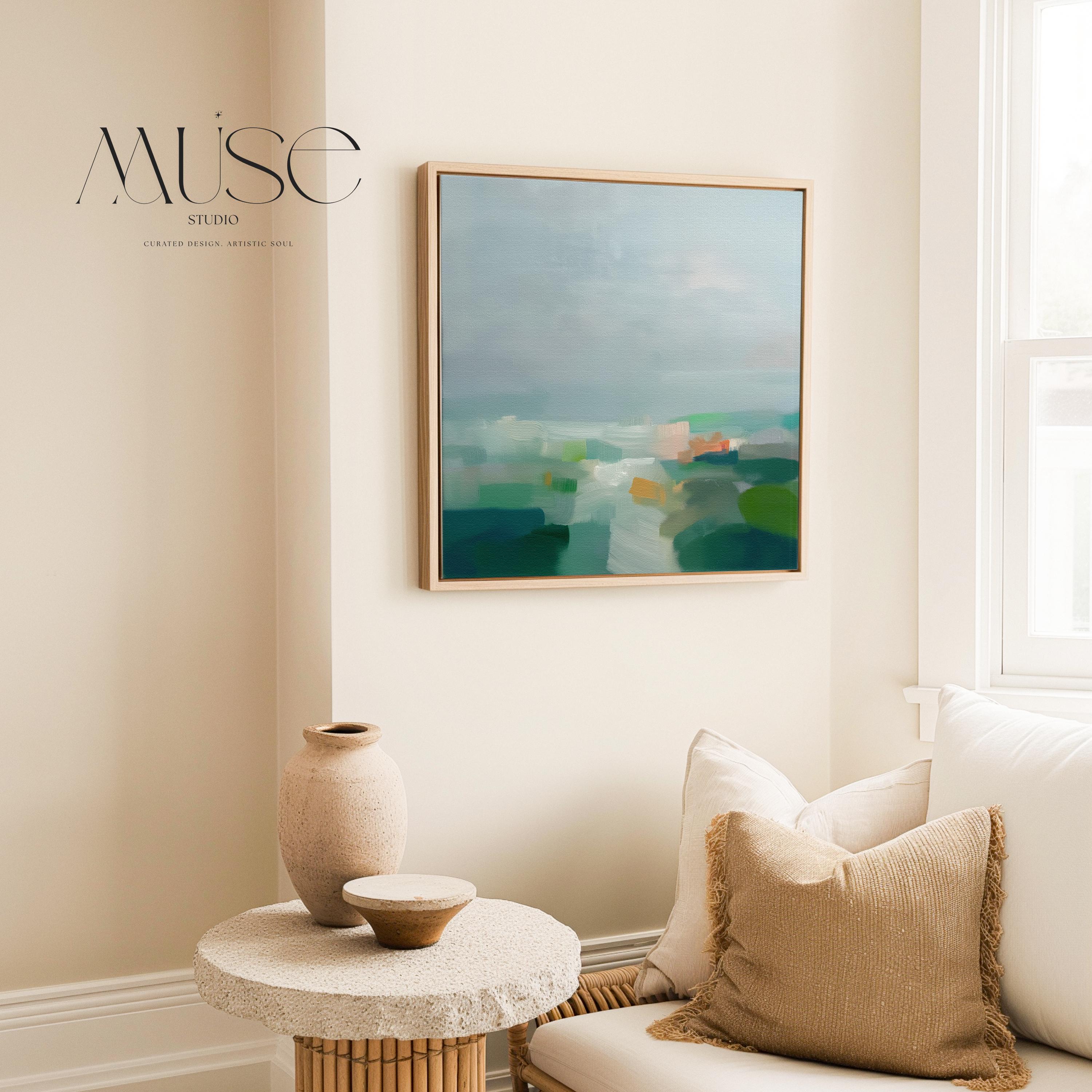 Large square abstract decor wall art featuring mist blue, sea glass green, and soft teal tones, framed in natural wood and styled in a calm contemporary living room, creating a serene coastal-inspired focal point for spacious interiors.