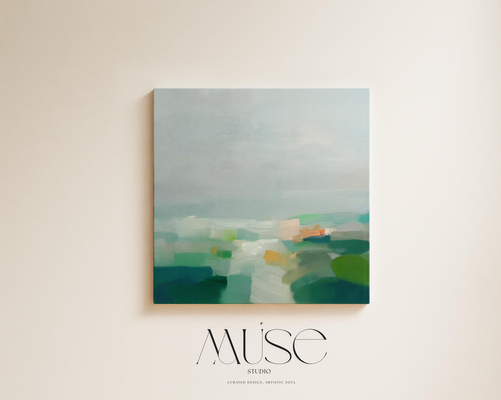 Large square abstract canvas wall art featuring soft green, aqua, and muted blue tones in a calming landscape composition, styled in a neutral interior to create an airy, refined focal point for living rooms or bedrooms.