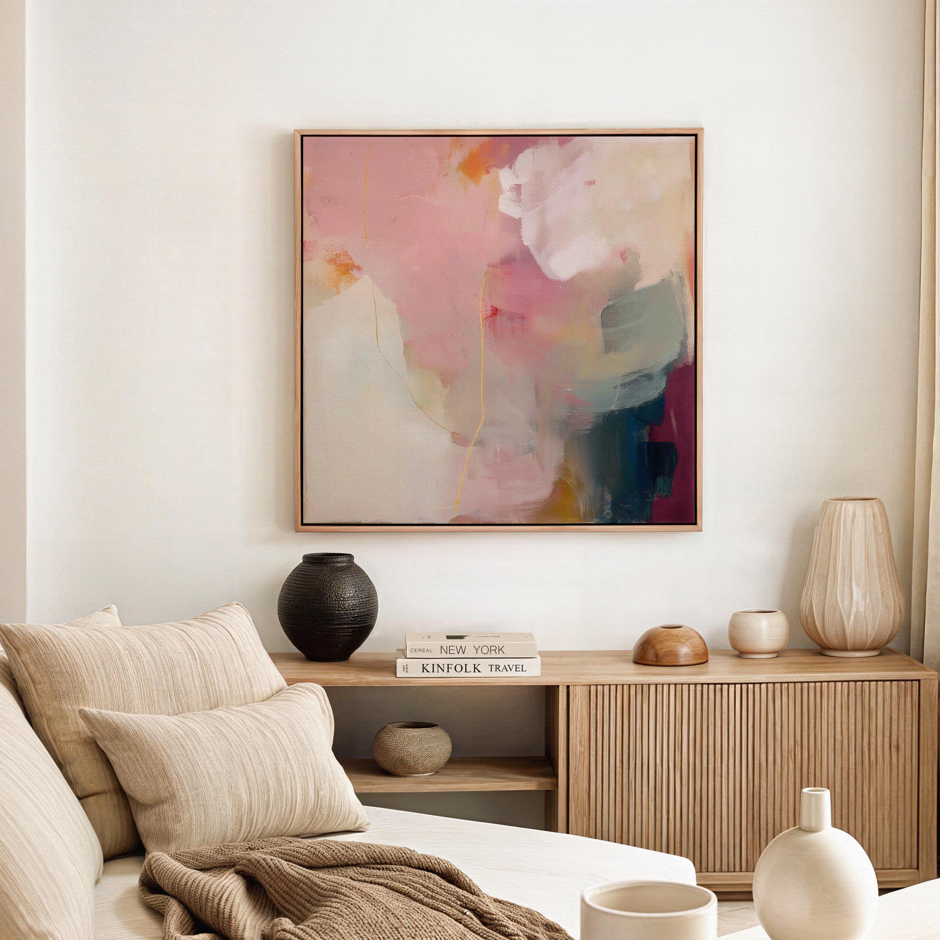 Large square abstract wall art in blush pink, warm cream, muted coral, and deep plum tones, printed as gallery-wrapped large canvas wall art, styled above a neutral sofa to create a romantic, painterly focal point for living rooms or bedrooms.