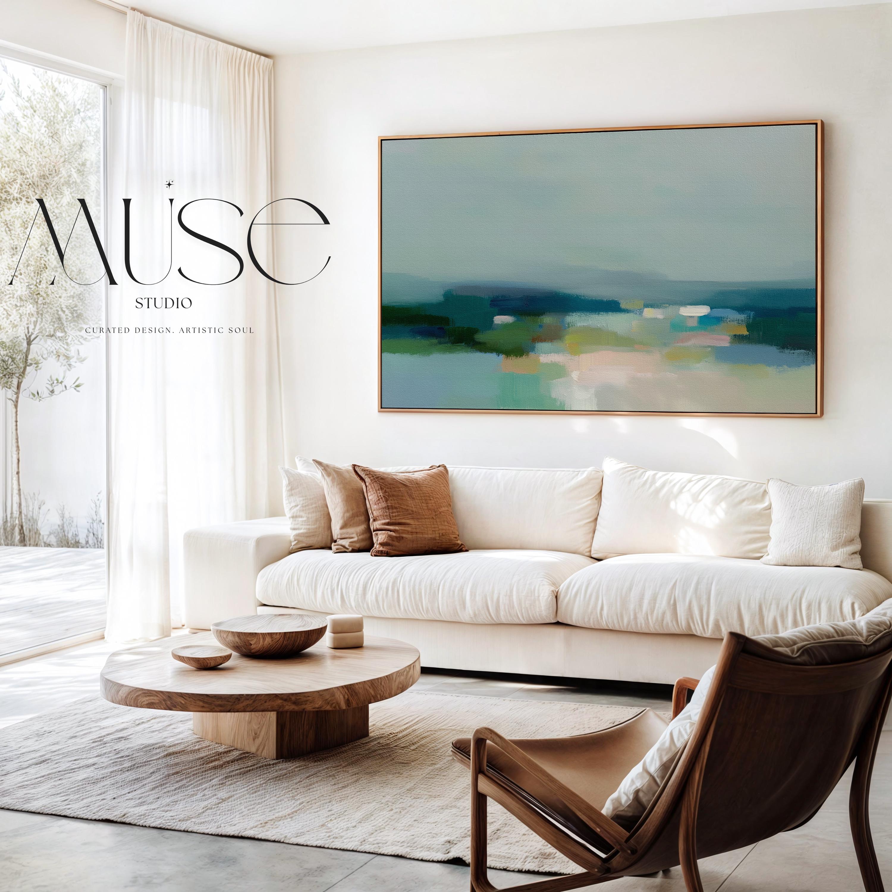 Muse Studio large framed canvas wall art in a coastal neutral abstract composition featuring soft teal, sage, and sand tones with layered horizon movement, printed with museum-grade giclée inks on premium artist canvas and framed in natural wood for living room styling.