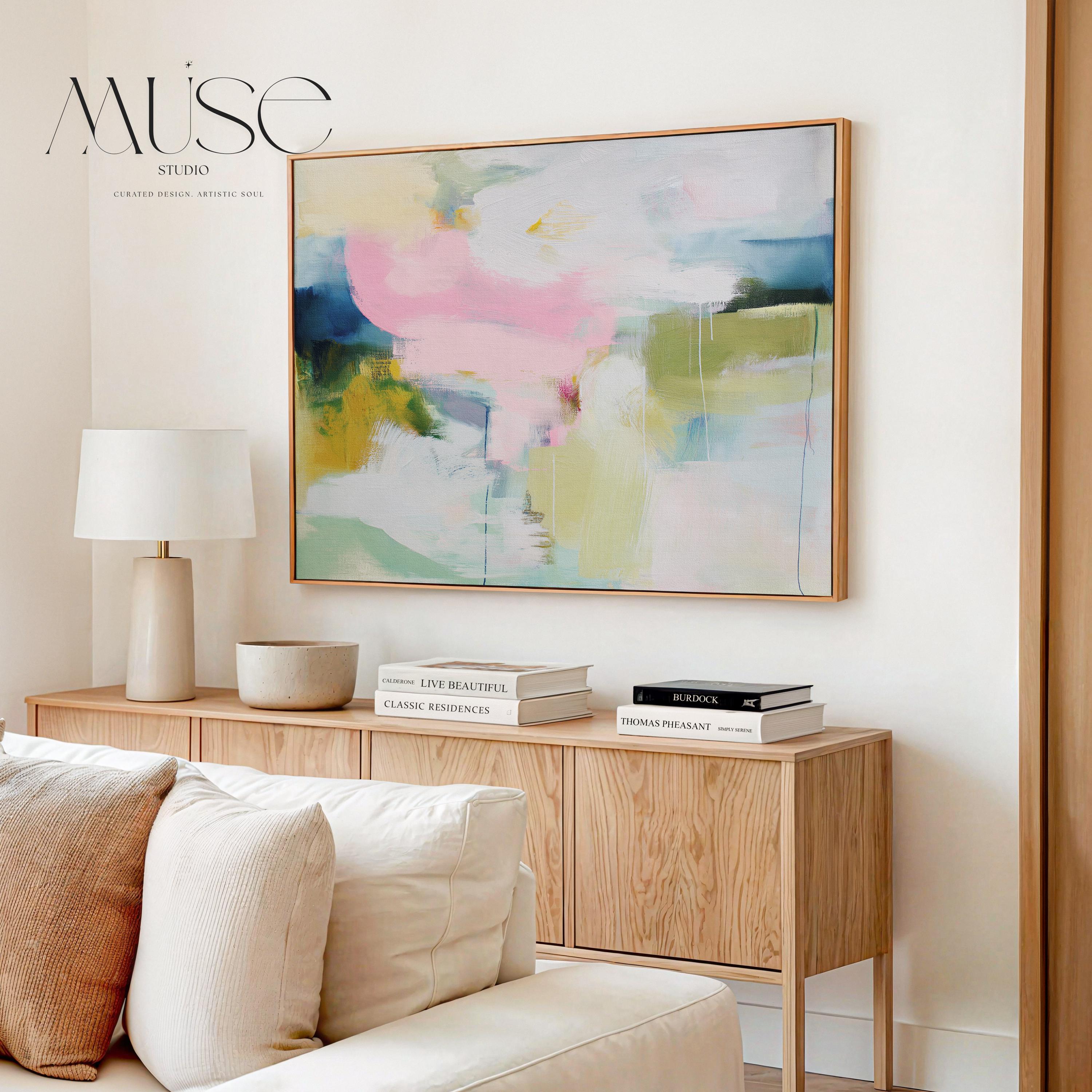 Muse Studio large framed canvas wall art featuring a soft pastel abstract composition in blush pink, olive, mint, mustard, and sky tones, printed with museum-grade giclée inks on premium artist canvas for living room decor.