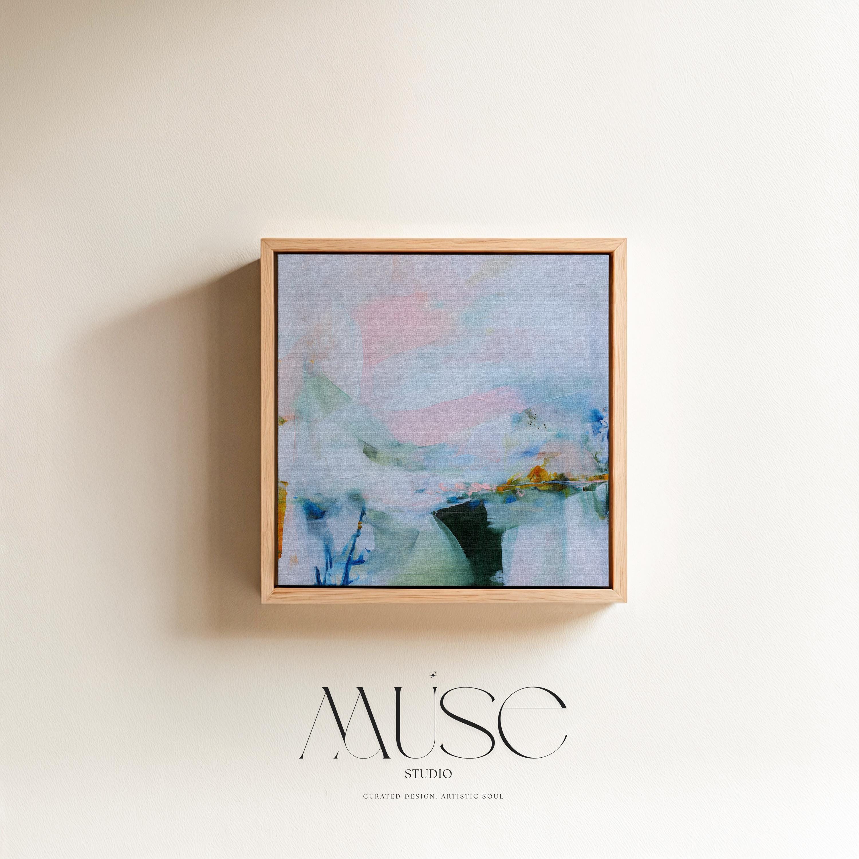 Muse Studio framed abstract wall art in soft blush, misted blue, pale sage, and deep teal with warm ochre accents, printed with museum-grade giclée inks on premium gallery-wrapped canvas, set in a natural wood float frame, styled above a neutral linen sofa in an organic transitional living room with warm oak tones and layered textures.