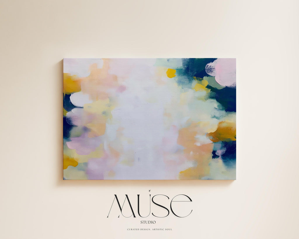 Muse Studio large horizontal abstract canvas wall art printed with museum-grade giclée inks on premium gallery-wrapped canvas, featuring blush and navy pastel tones in an Organic Transitional style, styled above a bed in a serene coastal bedroom.