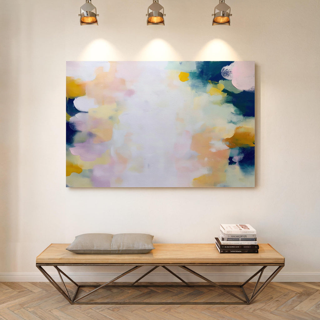 Muse Studio large horizontal abstract canvas wall art printed with museum-grade giclée inks on premium gallery-wrapped canvas, featuring blush and navy pastel tones in an Organic Transitional style, styled above a bed in a serene coastal bedroom.
