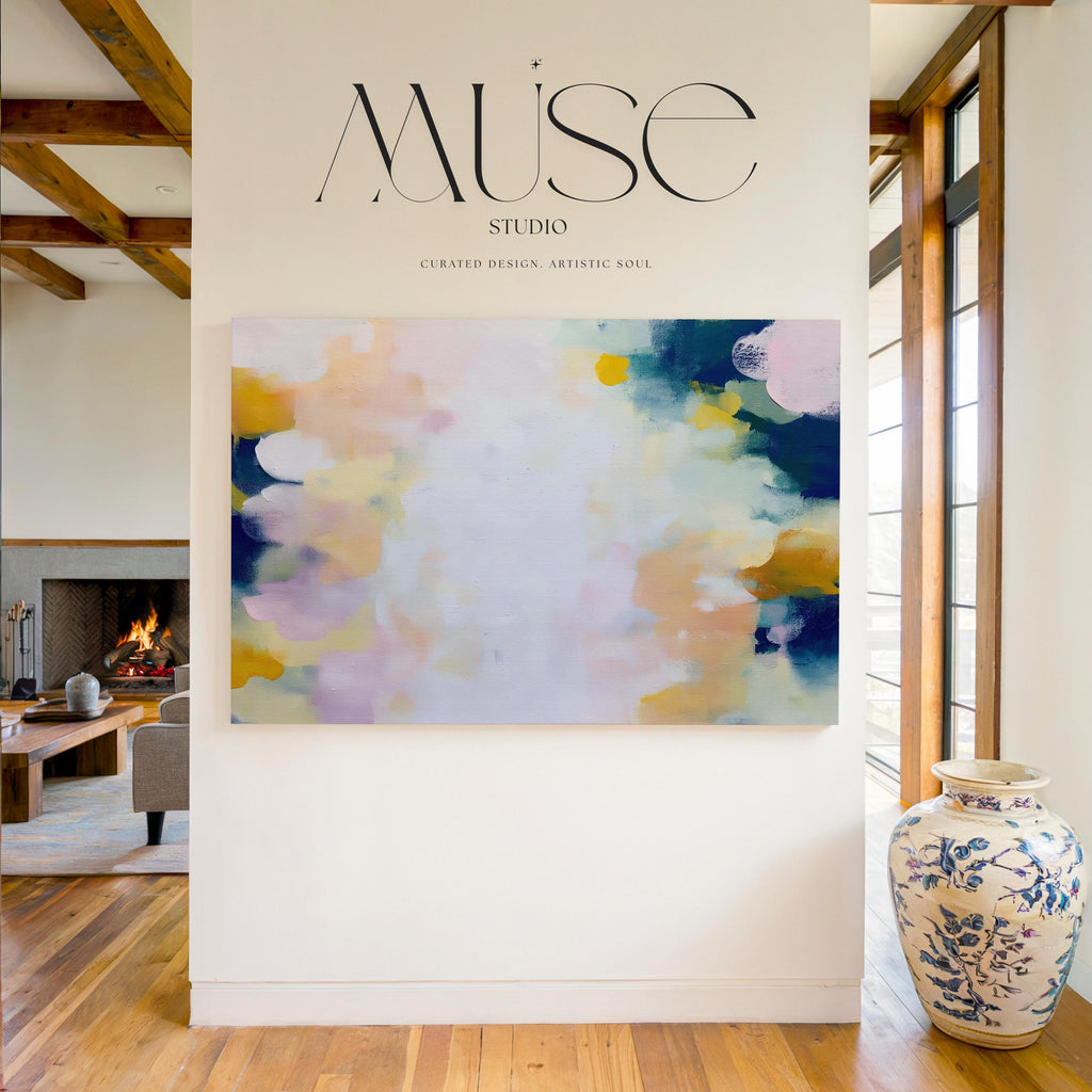 Muse Studio large horizontal abstract canvas wall art printed with museum-grade giclée inks on premium gallery-wrapped canvas, featuring blush and navy pastel tones in an Organic Transitional style, styled above a bed in a serene coastal bedroom.
