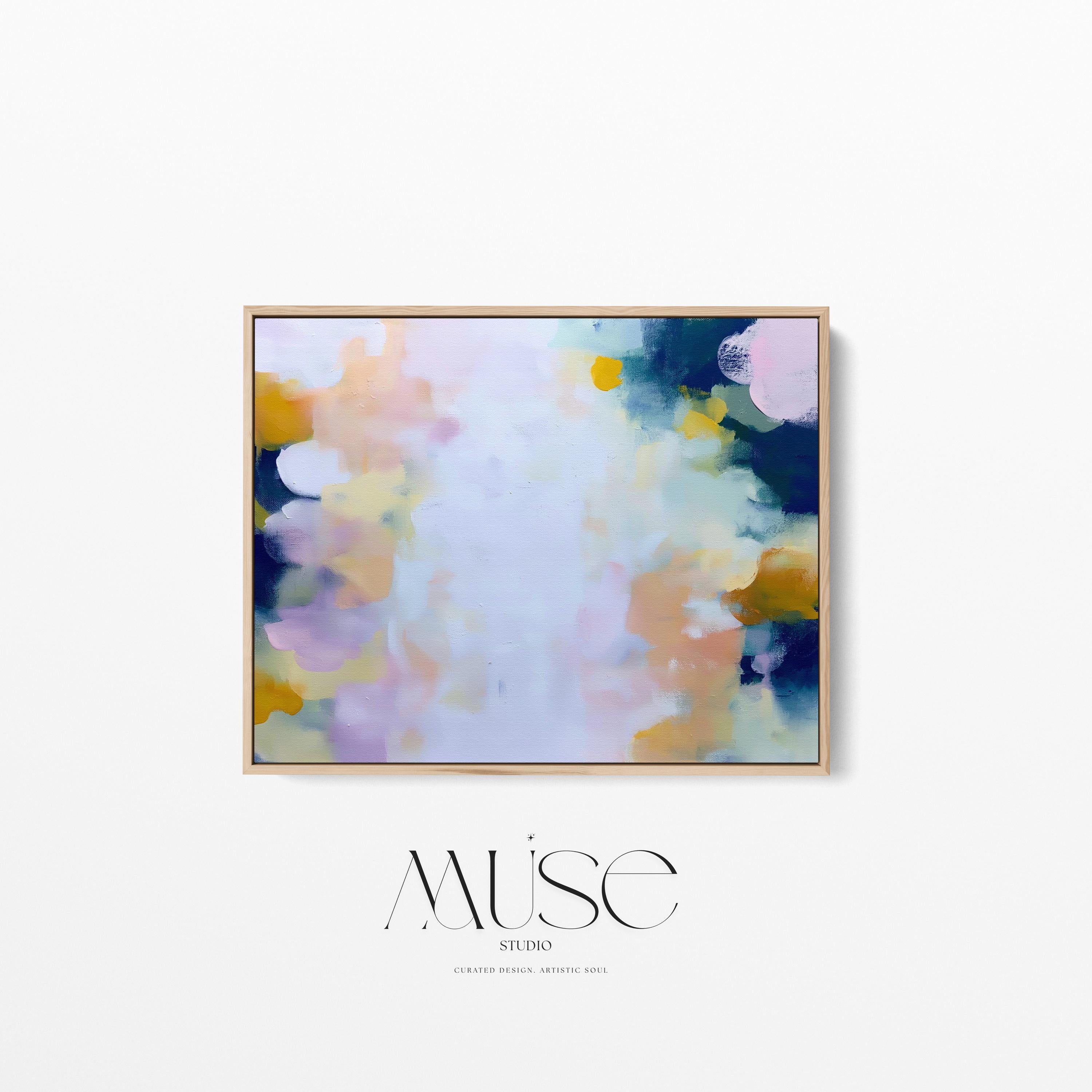 Muse Studio large horizontal framed abstract wall art printed with museum-grade giclée inks on premium gallery-wrapped canvas, featuring blush and navy pastel tones in an Organic Transitional style, styled above a linen sofa in a coastal living room.