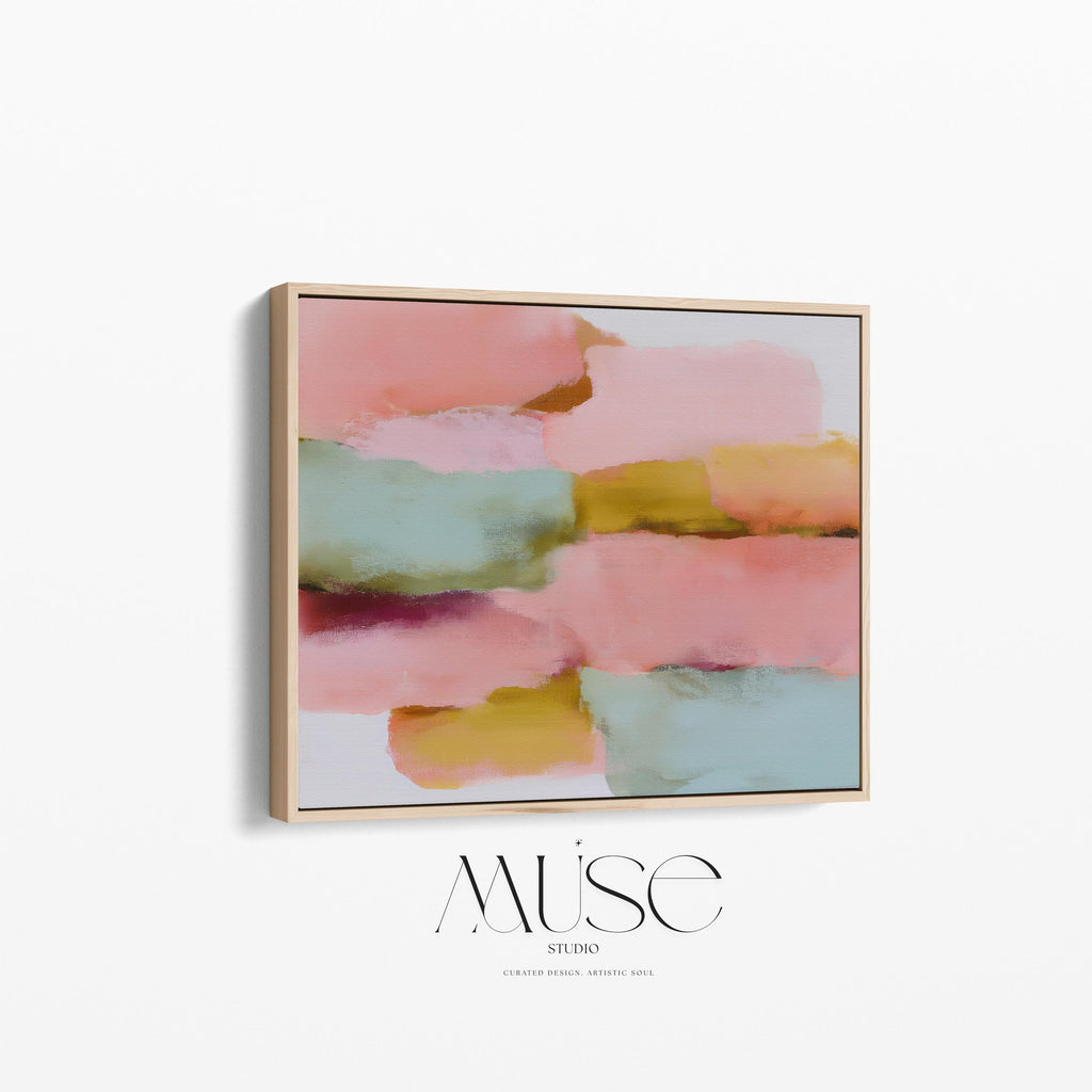 Large horizontal abstract framed canvas wall art featuring blush pink, coral, muted aqua blue, golden ochre, and plum layered brushstrokes, styled above a neutral sofa in a modern living room, offering warm contemporary color and balanced movement for oversized wall placement.